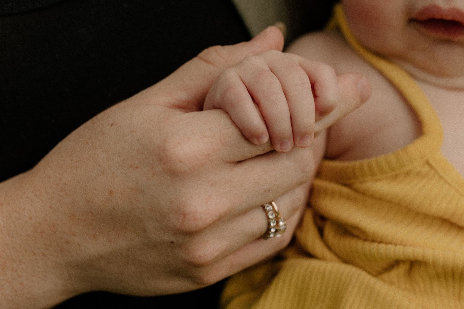 Hands reaching out in a gentle gesture against a blurred background for sweet family photo