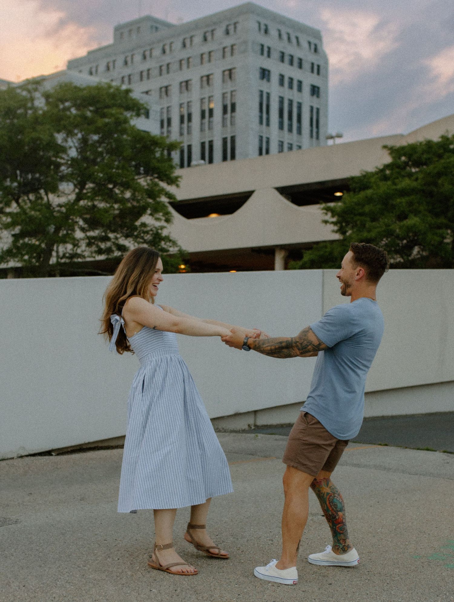 Couple dancing together on an urban rooftop at sunset in Madison, WI couples photography session.