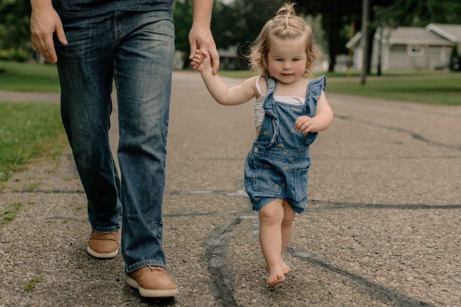 Family members walking together on a paved path in a park setting for outdoor family photos