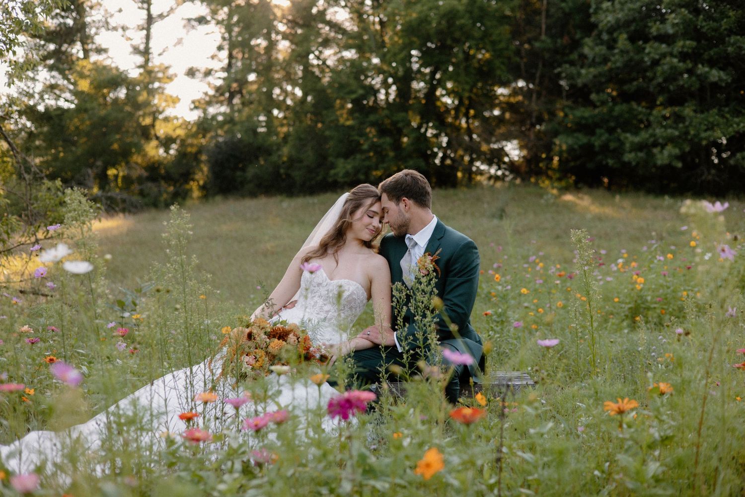 Bride and Groom pose in a Wisconsin Dells wildflower meadow during golden hour farm wedding photos