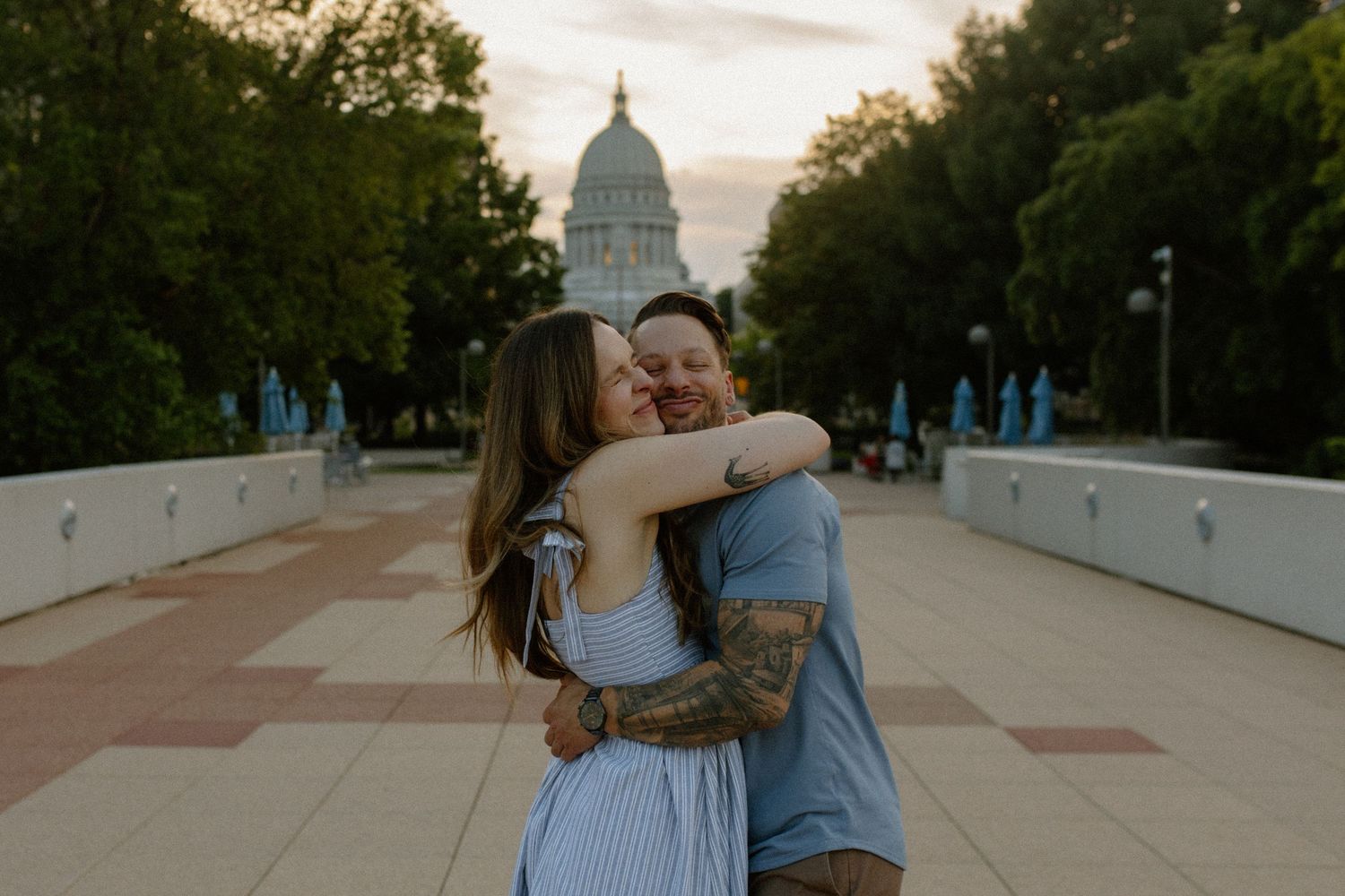Joyful dancing silhouettes against an evening sky near a capitol building for couples photography session