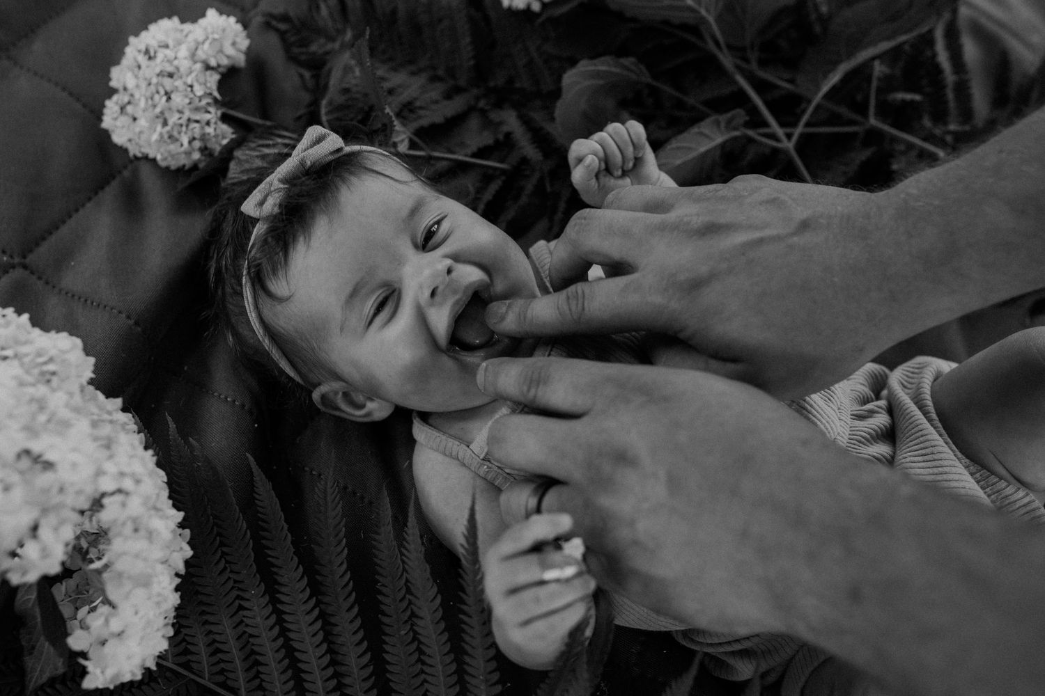 Black and white image of tender moments between a baby and father for family photos