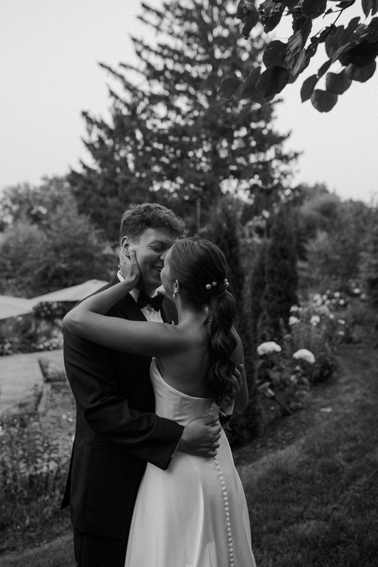 Black and white wedding portraits capture intimate moments in a garden setting at Wisconsin Gardens Wedding Center venue