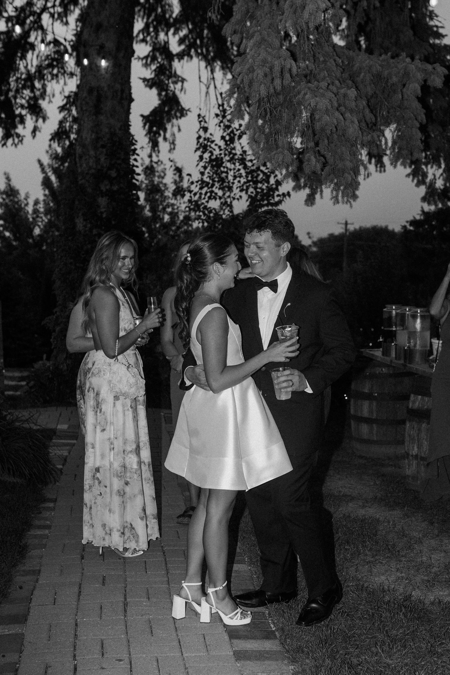 Evening wedding photos on garden path with couple in formal attire at Gardens Wedding Center wedding