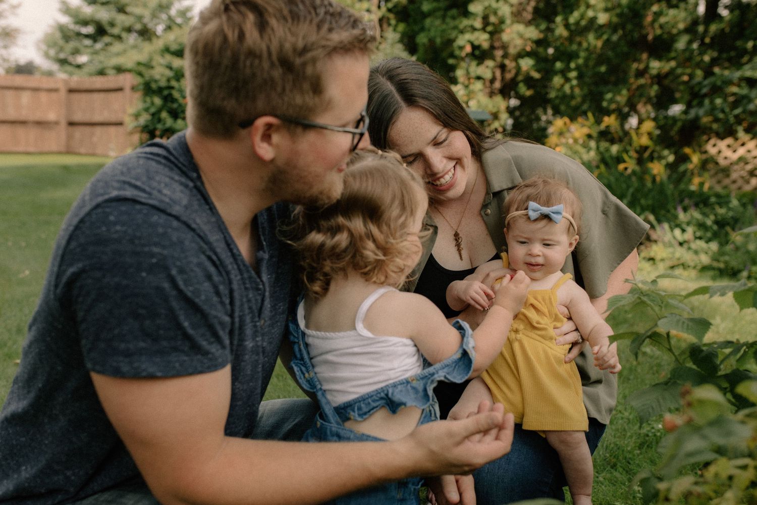 Family sharing intimate moments together in a lush garden setting for family photos