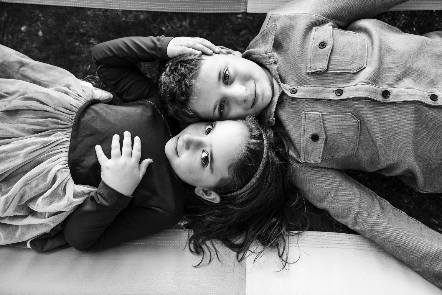Artistic black and white portrait series showing lying down poses.