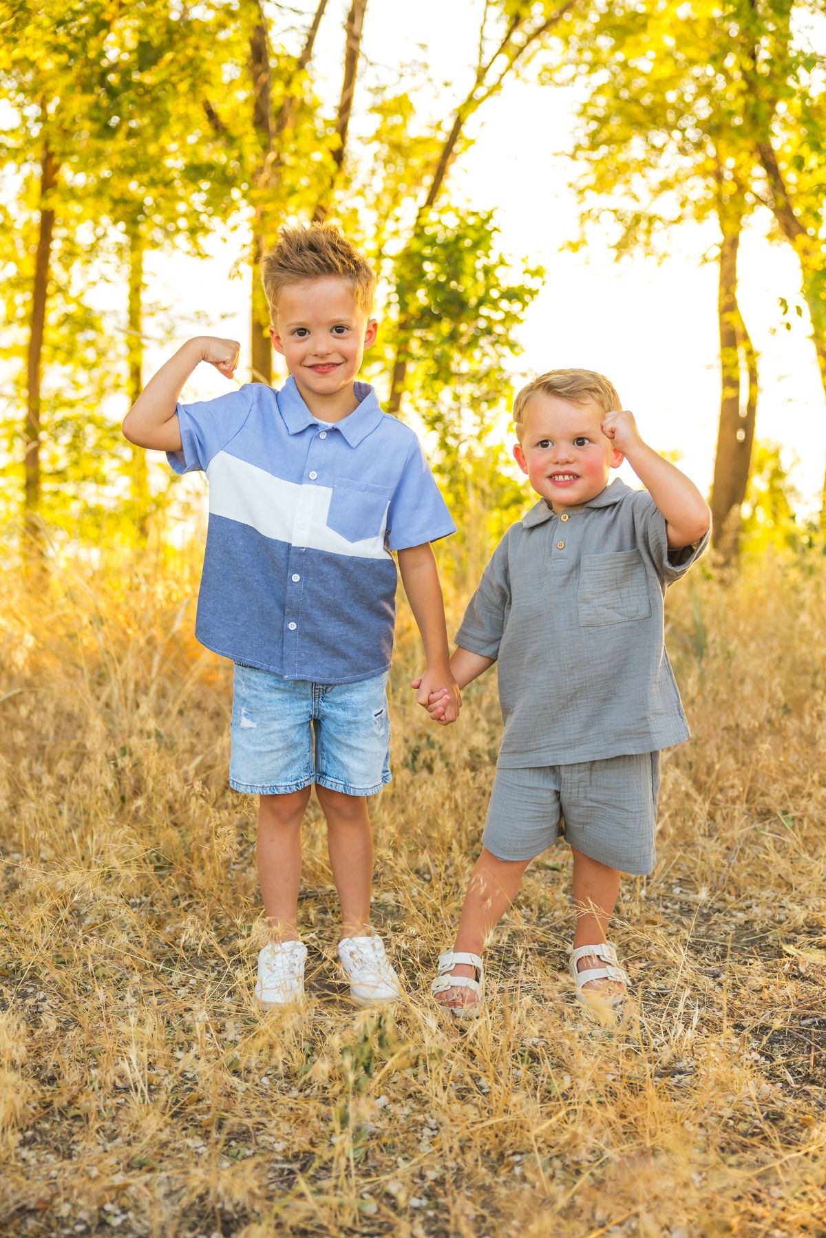 Young kids playing and laughing together outdoors during sunset.