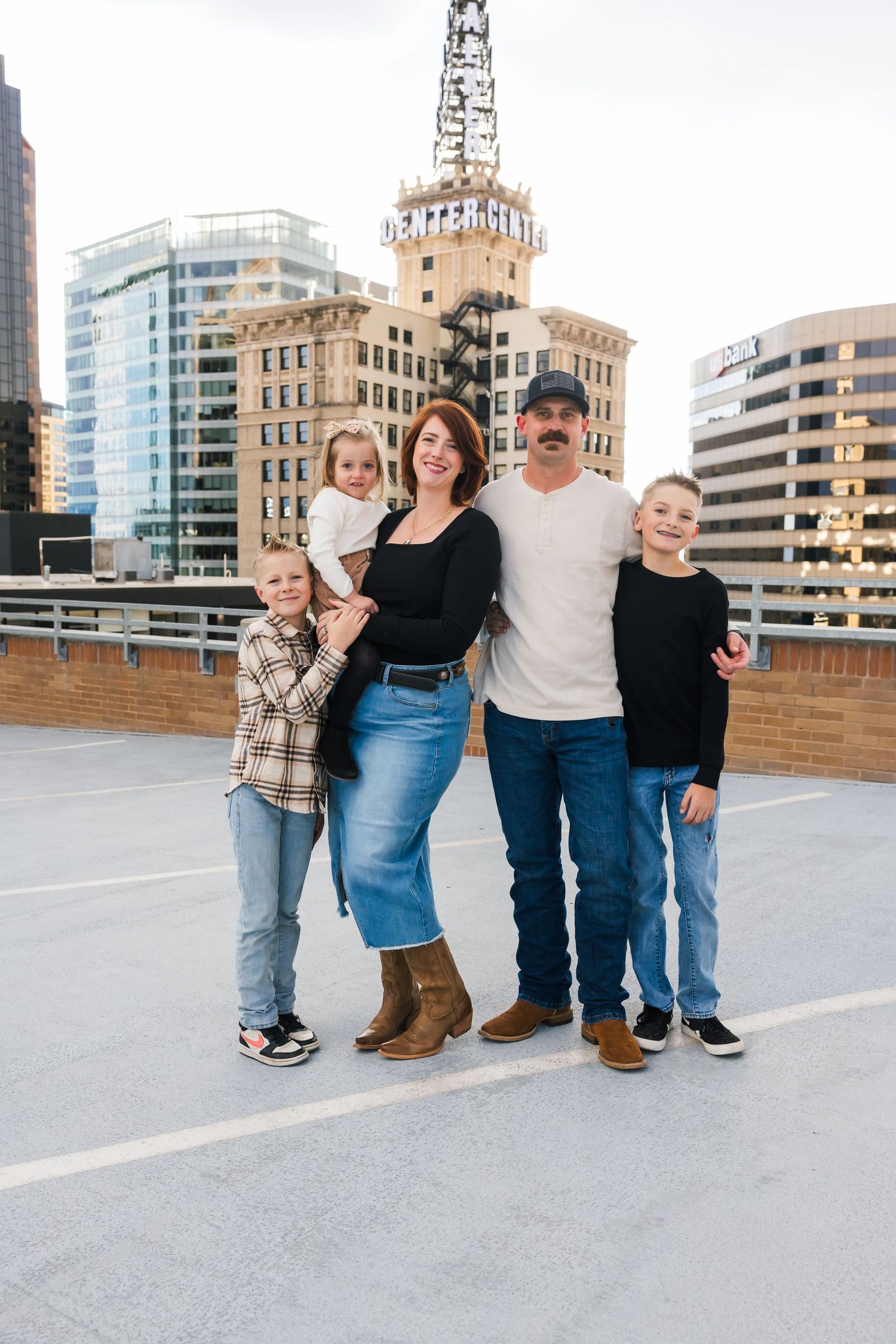 Urban family photoshoot on rooftop with city buildings in background salt lake city utah