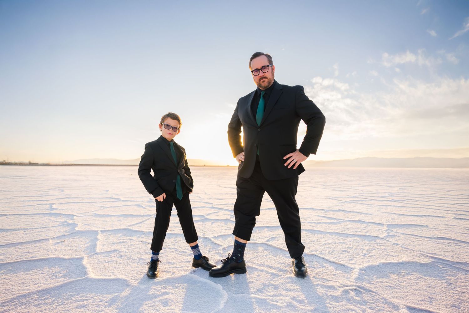 Series of silhouettes on a vast white salt flats during sunset at family portrait session natural light