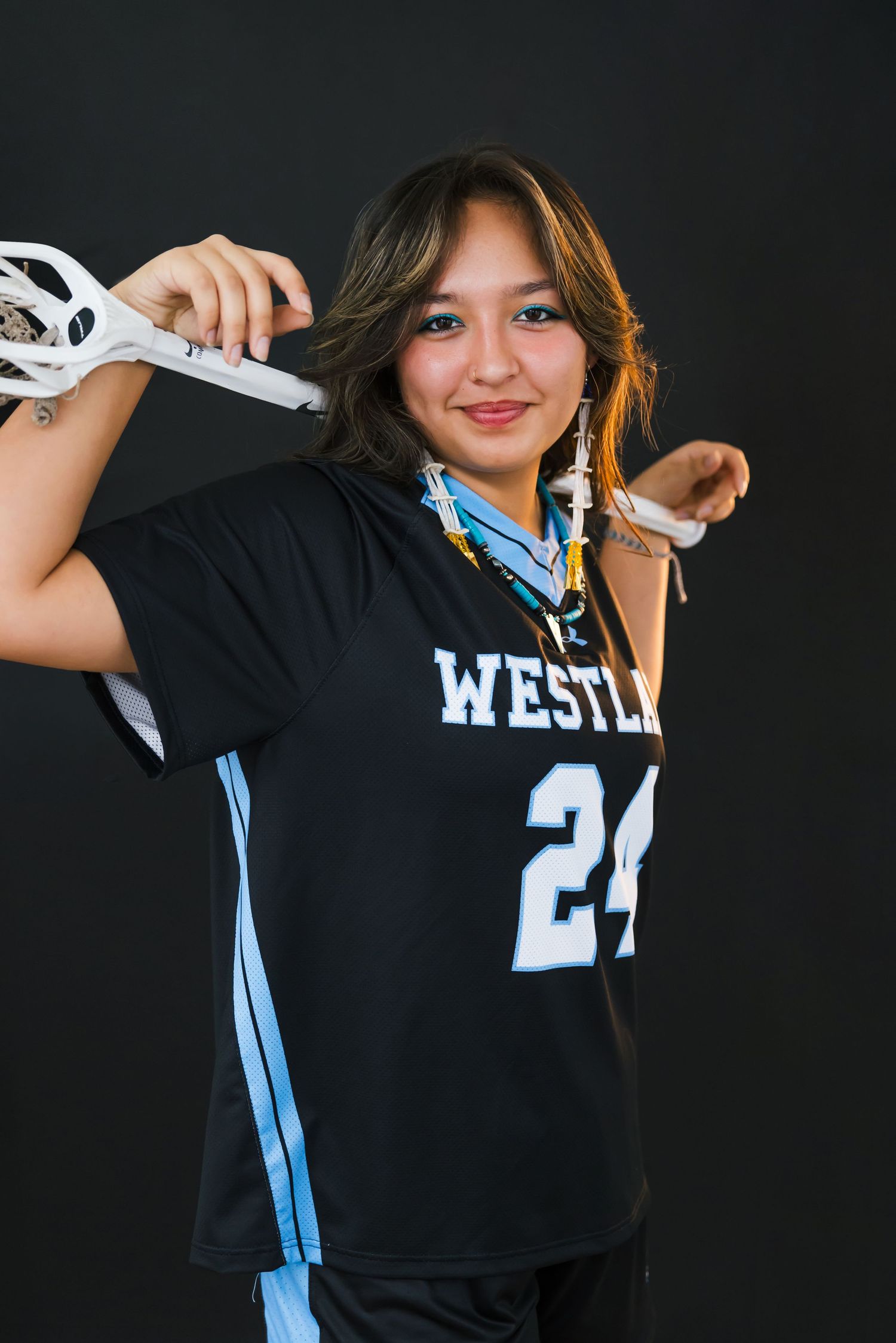 Utah senior girl lacrosse portrait in full uniform with stick
