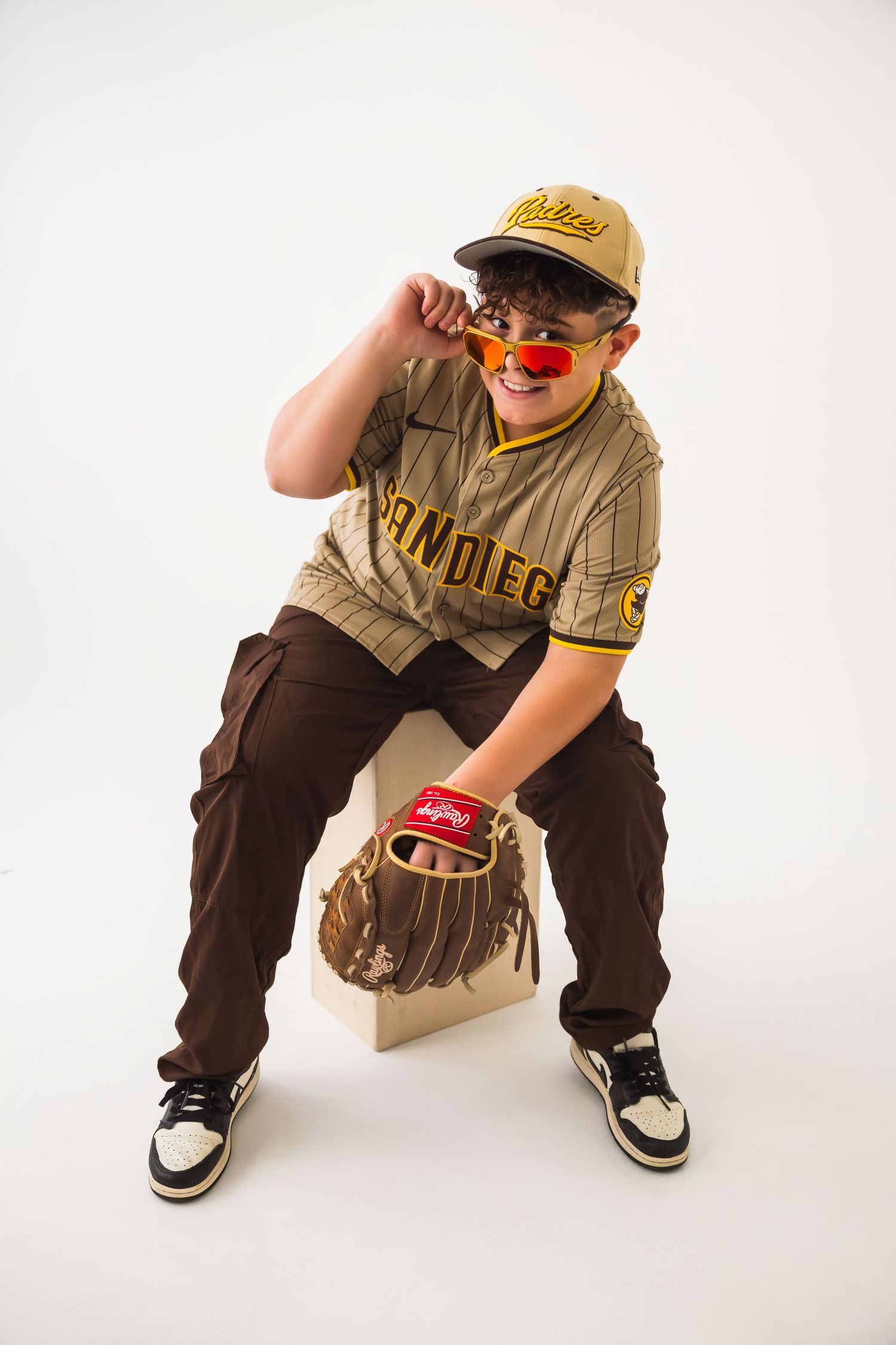 A series of dynamic poses showing a person in brown pants and beige shirt crouching against a white background.