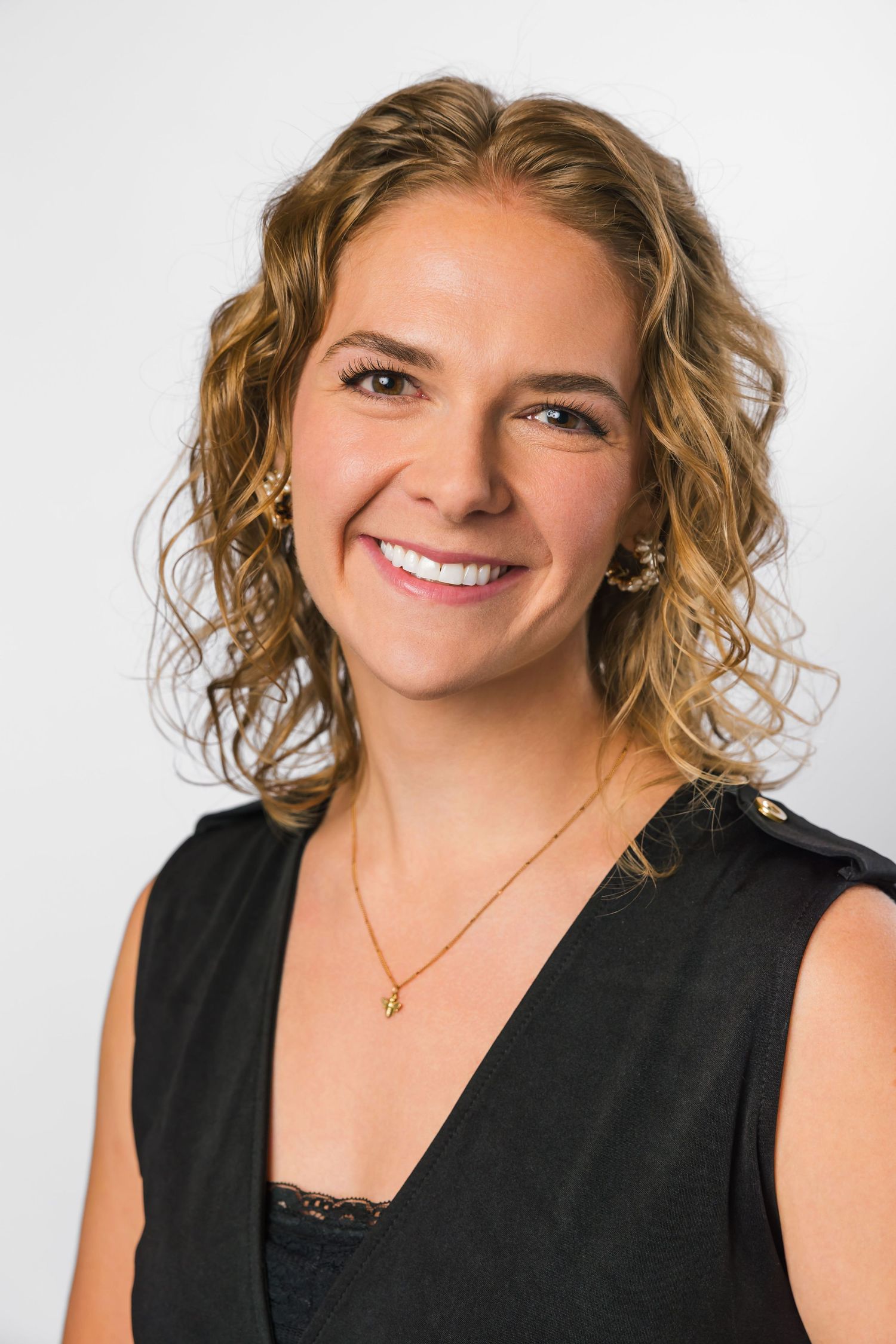 Professional headshot series showing warm smile and curly blonde hair against white background.