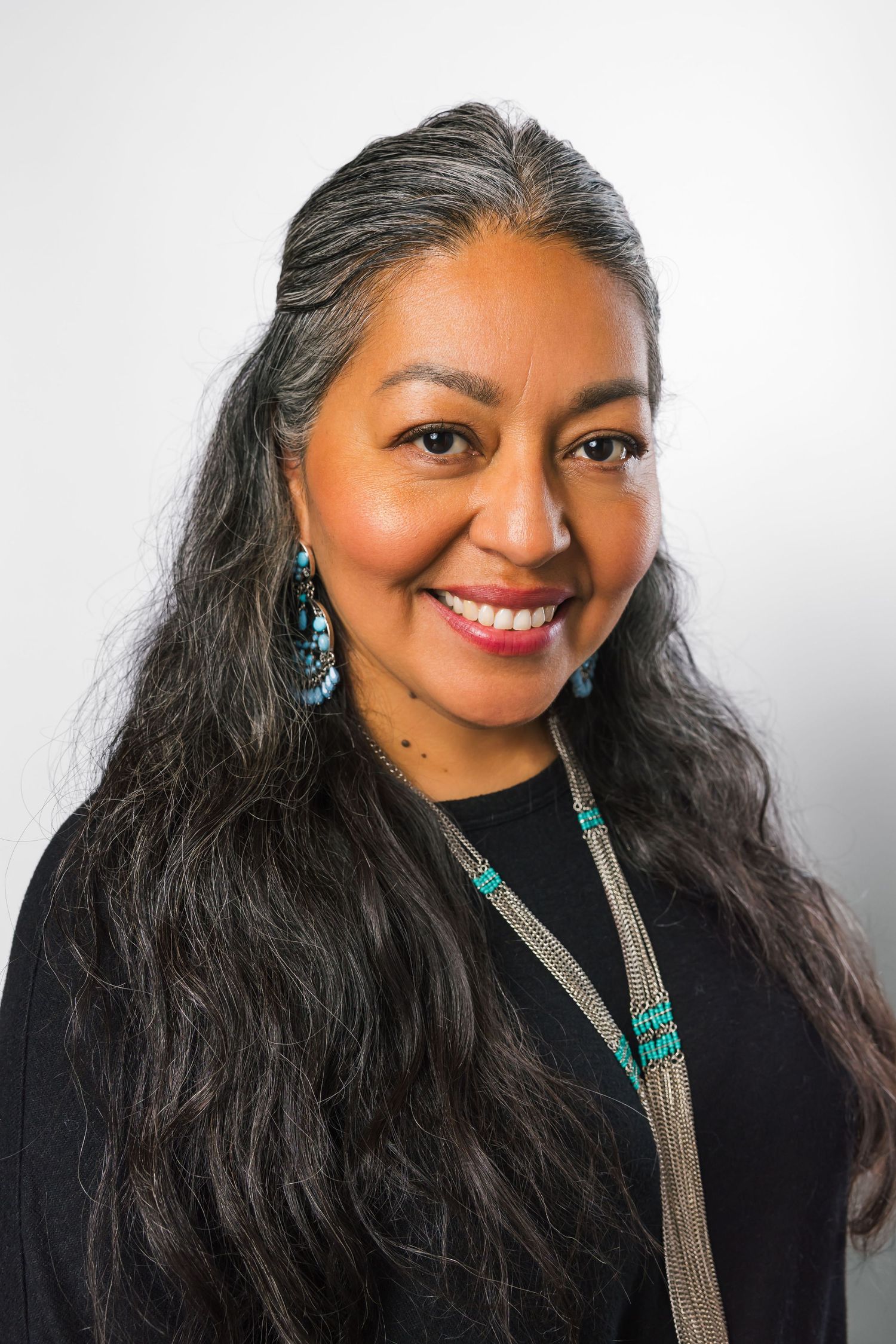 Professional headshot series against white background featuring turquoise jewelry and long dark hair.