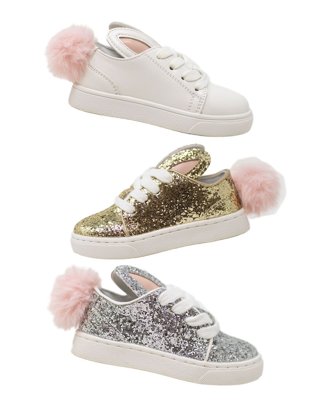 White sneakers with pink pompom details and gold glitter accents arranged in a stylish product display.