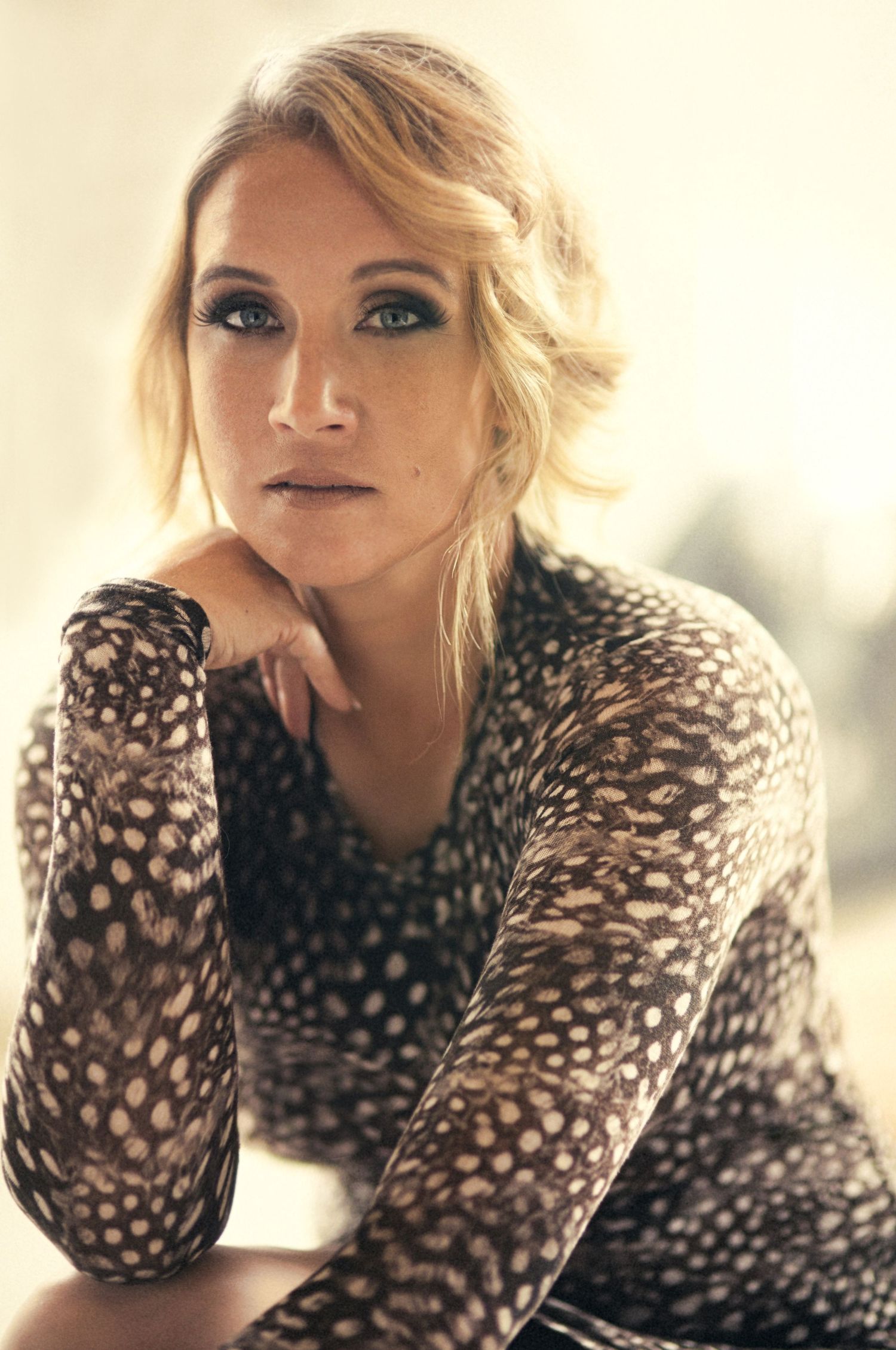 Fashion series in polka dot sweater with soft, dreamy lighting.