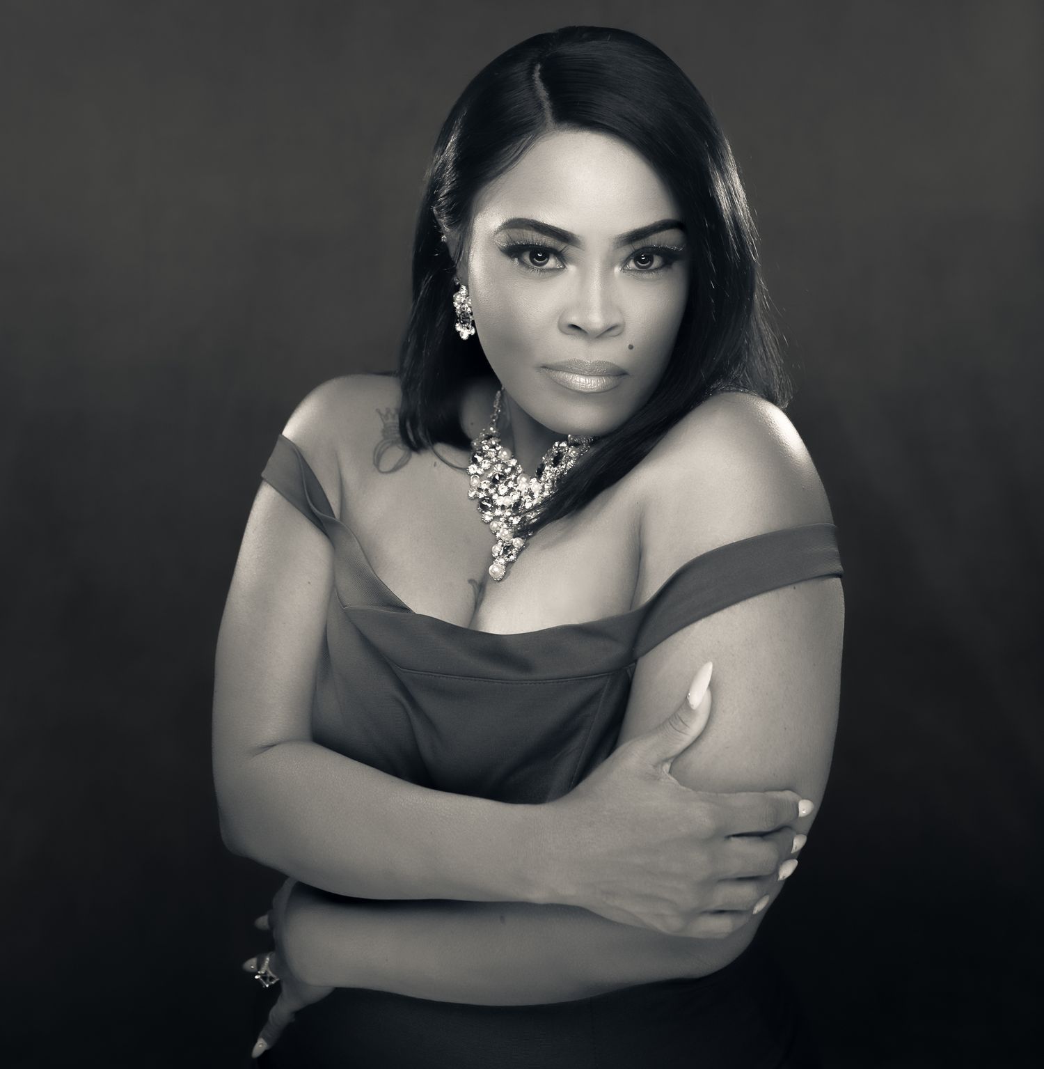 Dramatic black and white portraits showing elegant poses against dark background.