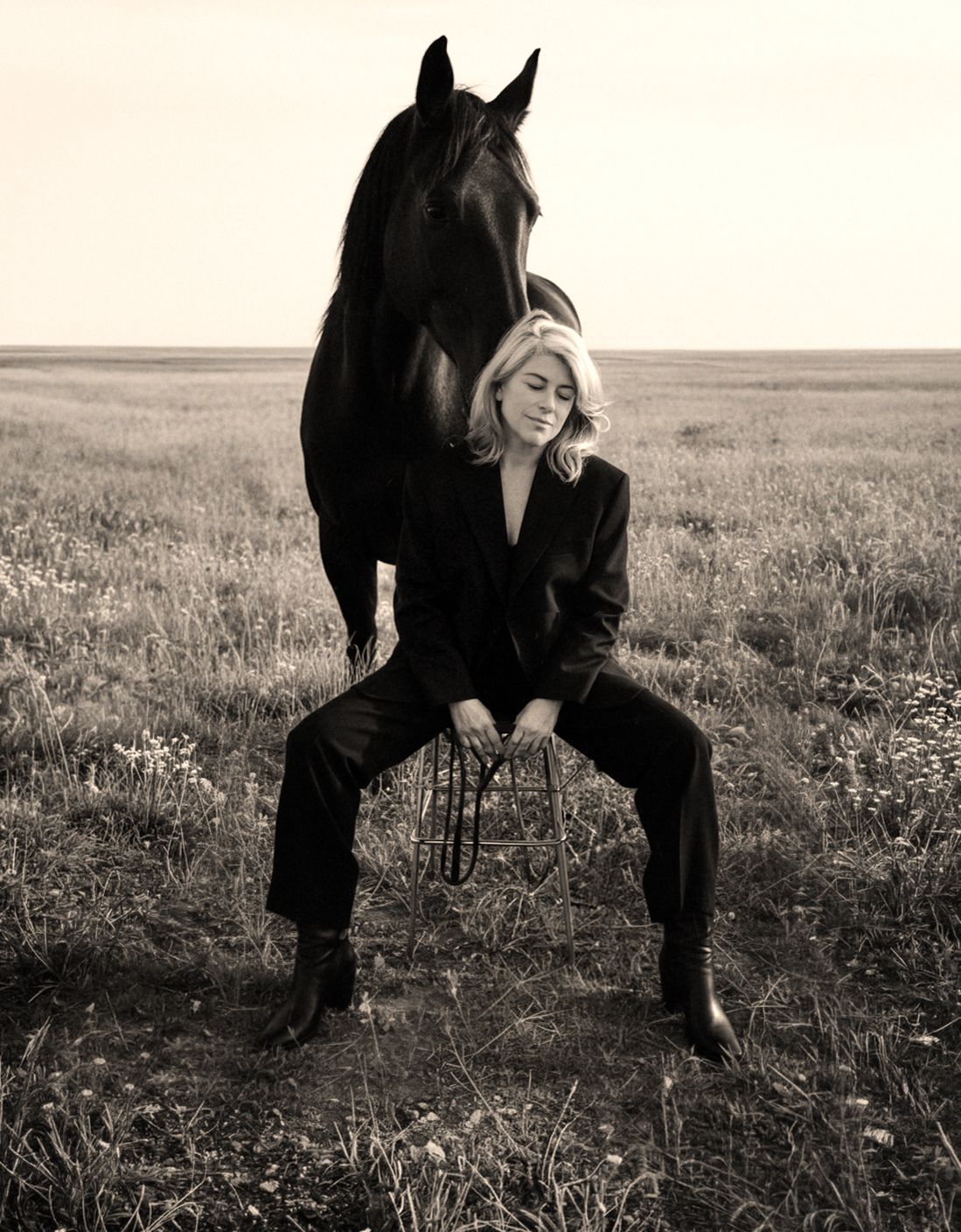 Artistic black and white photographs capturing intimate moments between a person and horse.