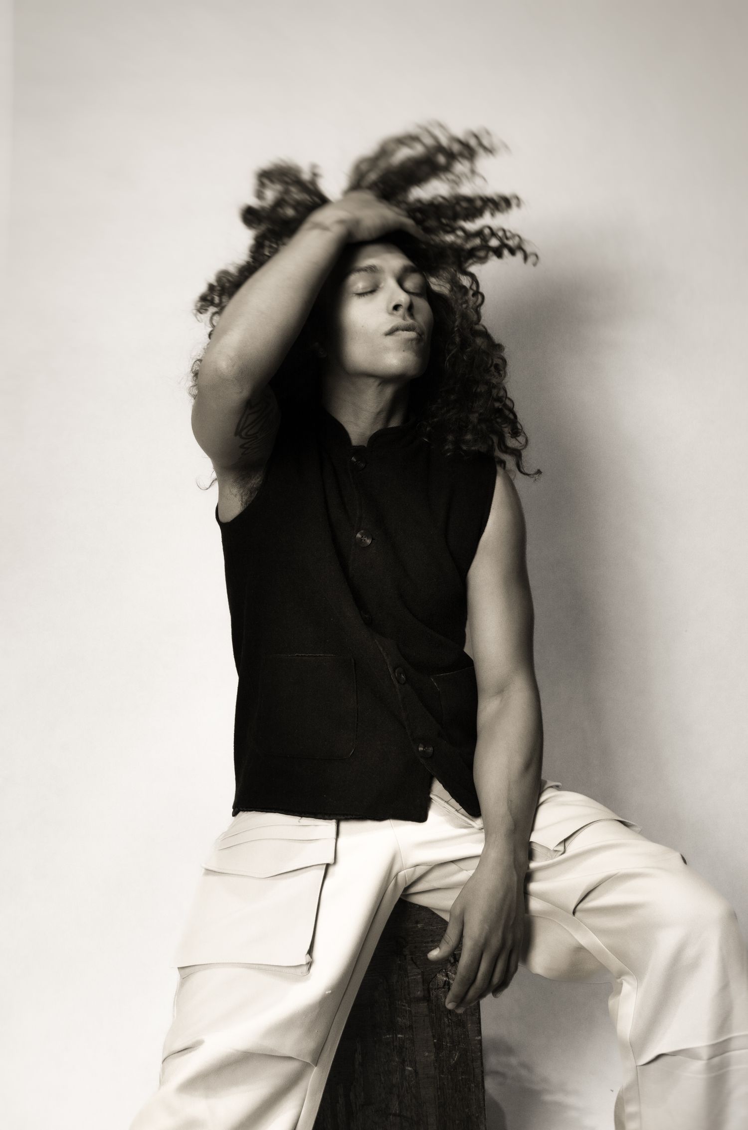 Artistic black and white portraits showing expressive movement in casual attire.