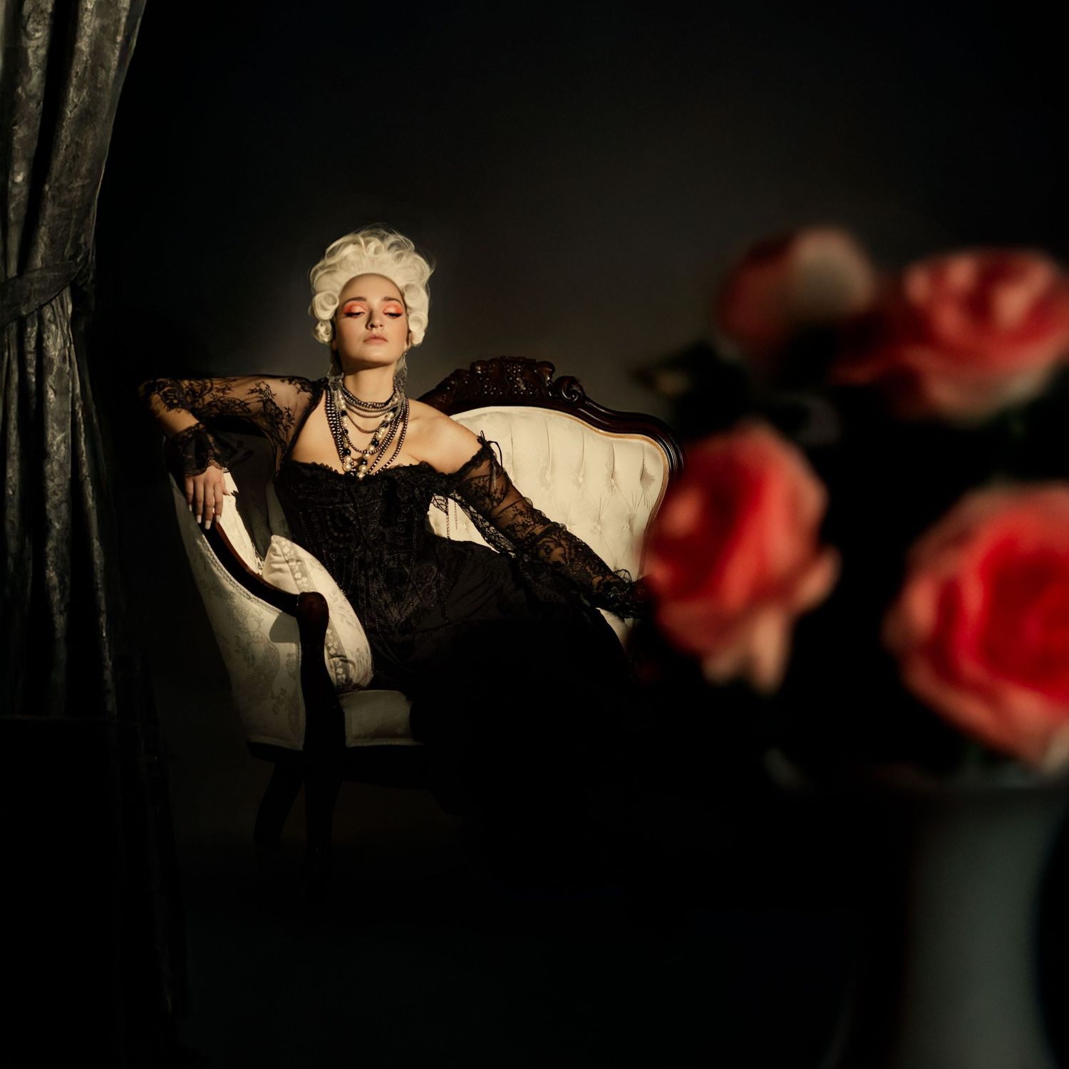 Artistic low-light photography series with roses and dramatic shadows creating a moody atmosphere.
