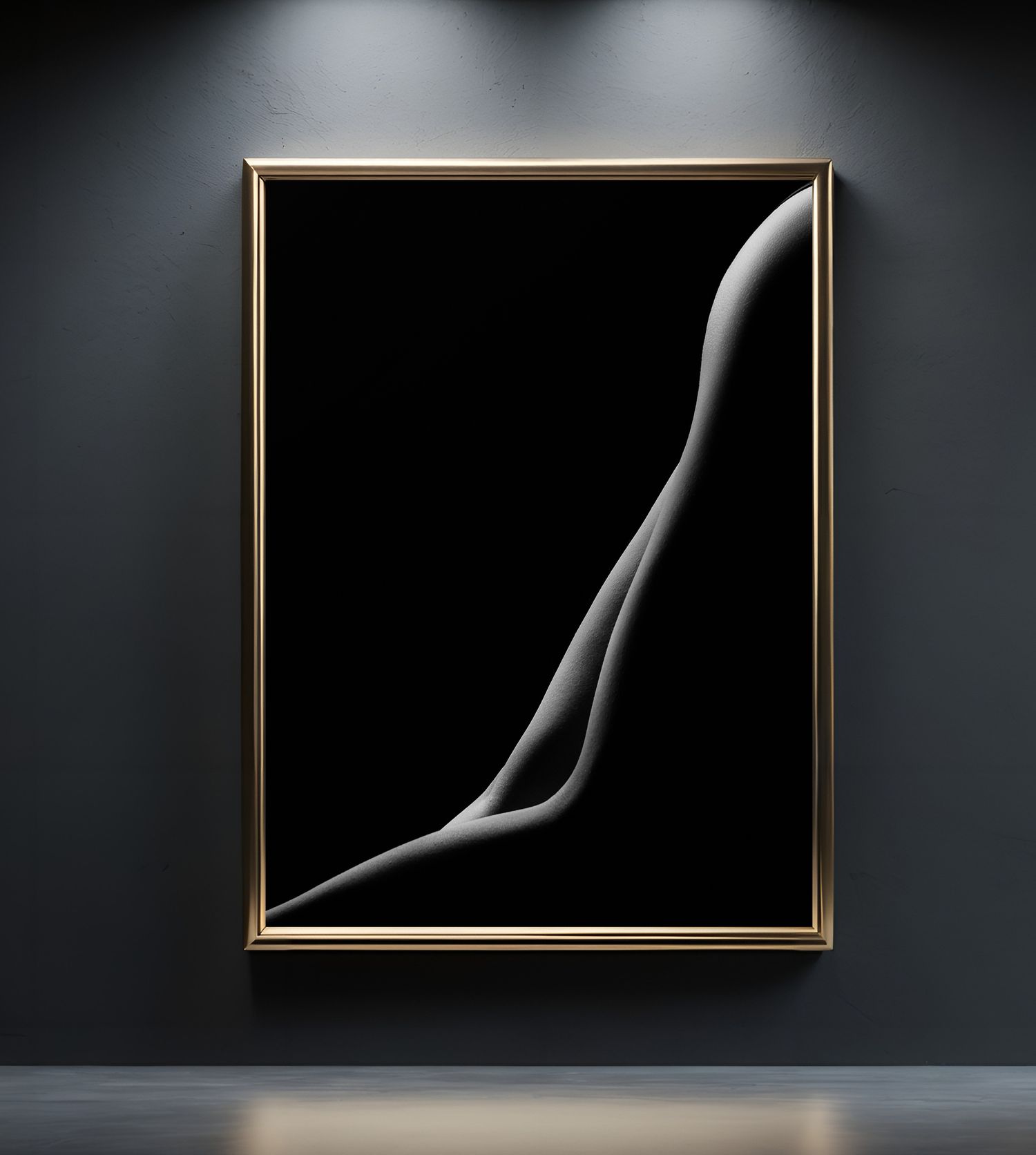 Black and white fine art nude photograph in a gold frame, displayed on a dark gray gallery wall.