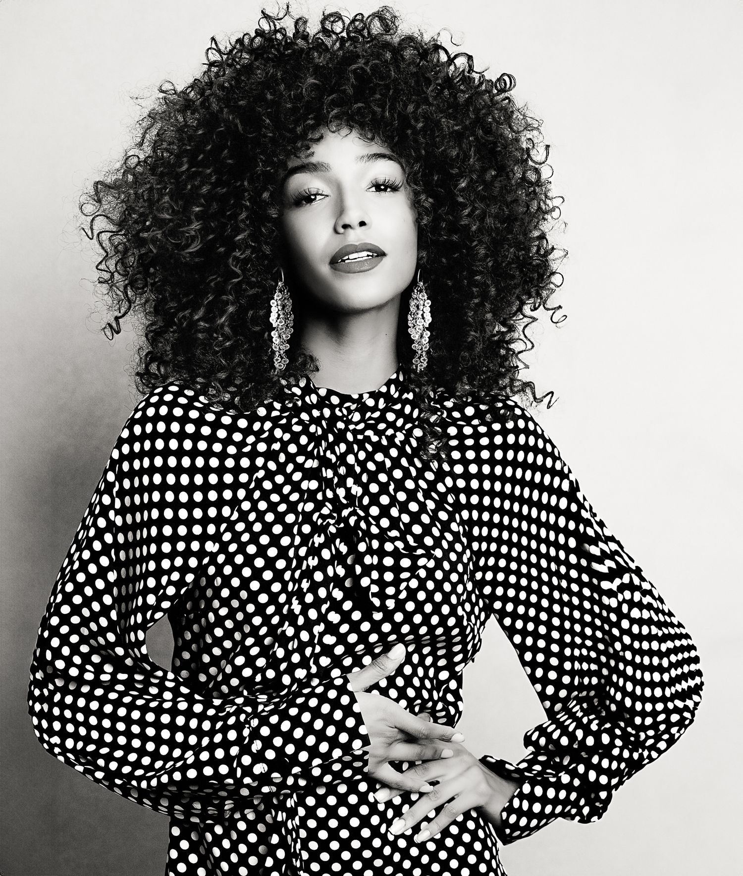 Black and white portraits featuring polka dot dress and voluminous curly hair.