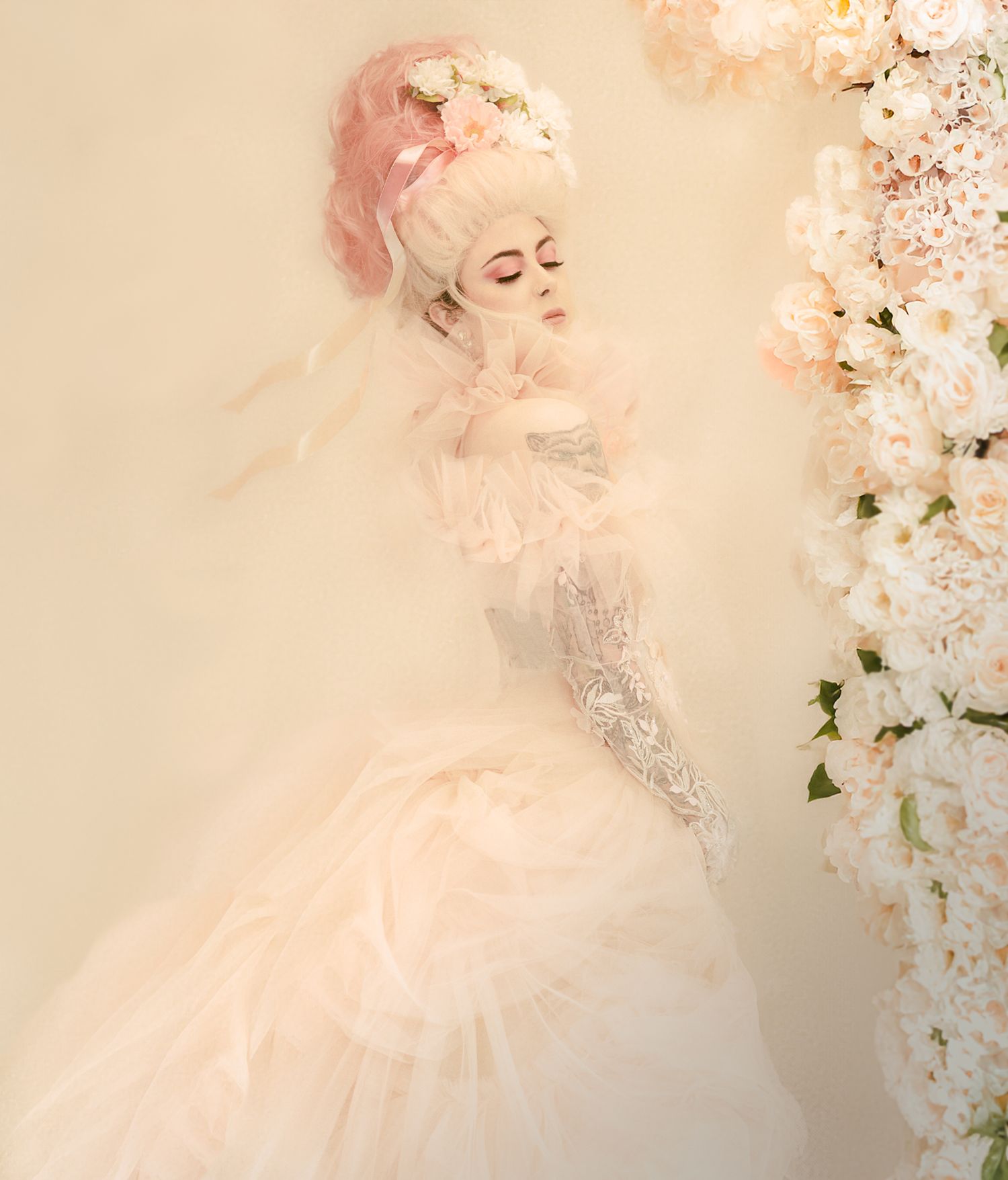 Ethereal portrait with soft pink tones featuring delicate white cherry blossoms and dreamy lighting effects.