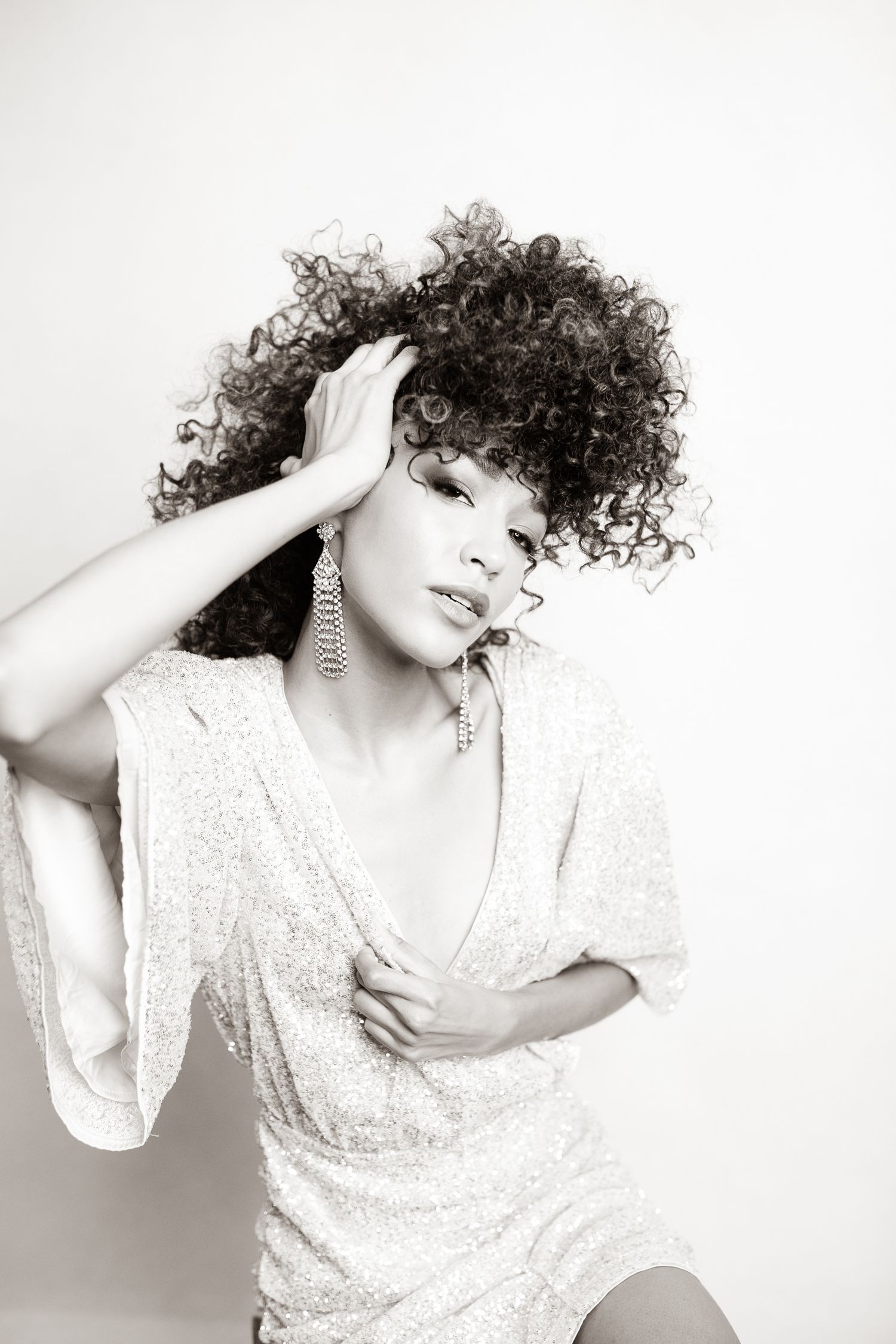 Artistic white background portraits featuring flowing white dress and expressive poses.