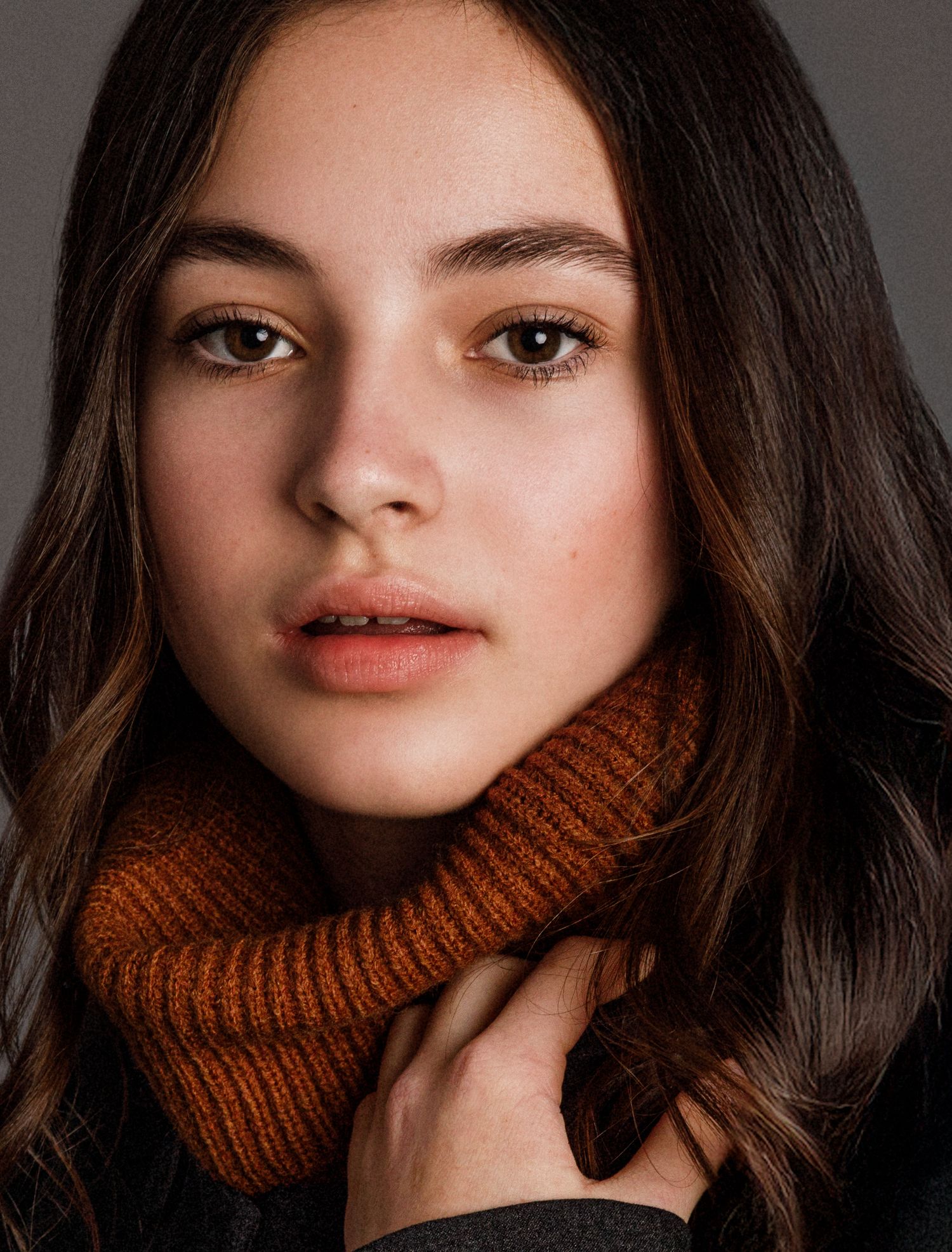 Close-up beauty portrait with brown turtleneck and natural makeup.
