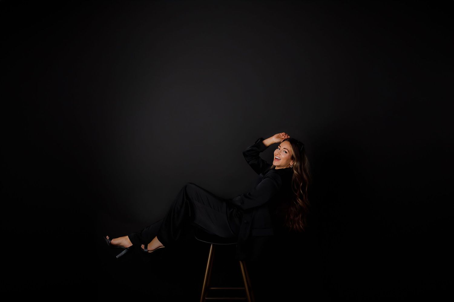Artistic low-key portraits in dark setting with dramatic lighting.