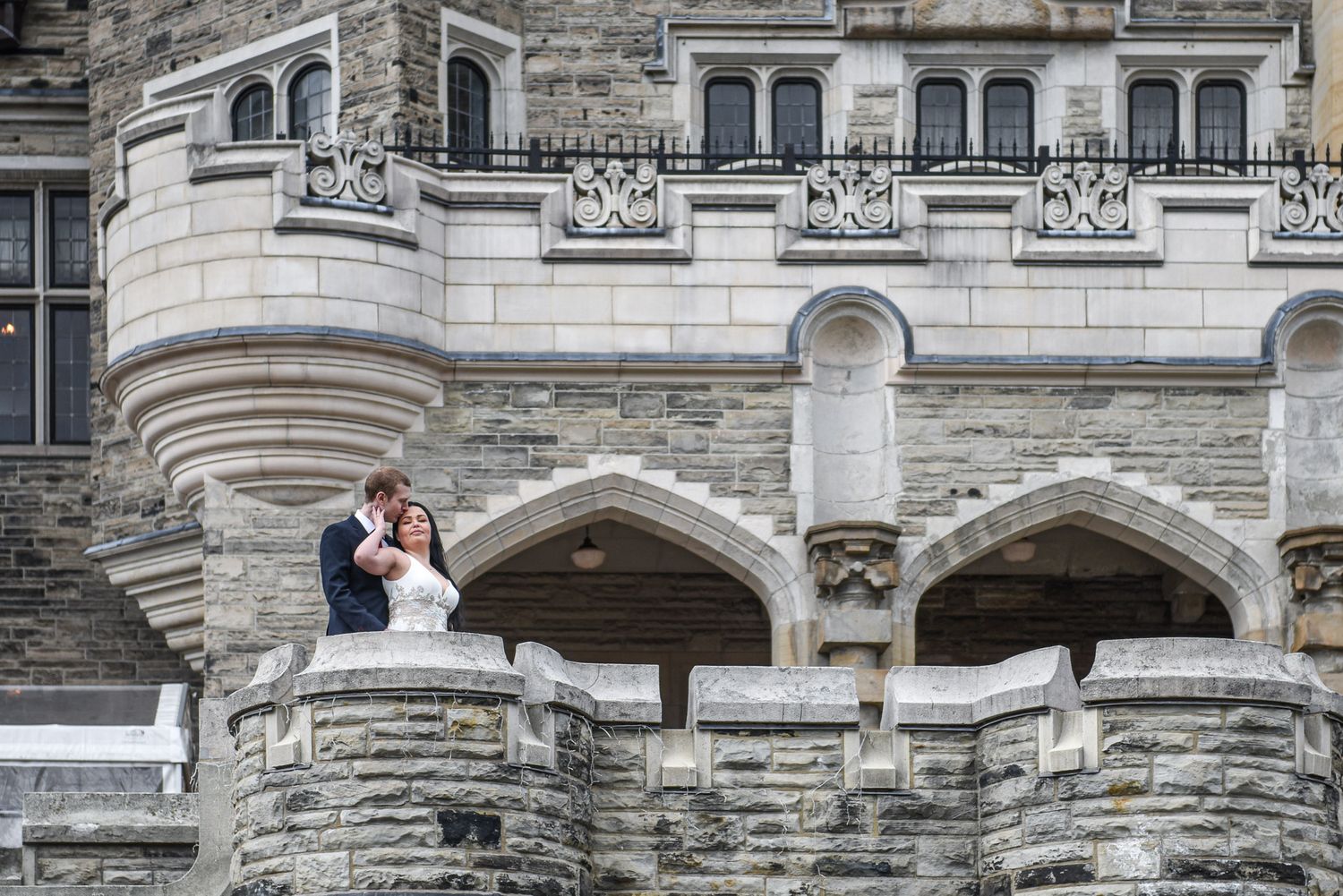 Elegant engagement session at Casa Loma in Toronto with a couple posing on the historic castle grounds.