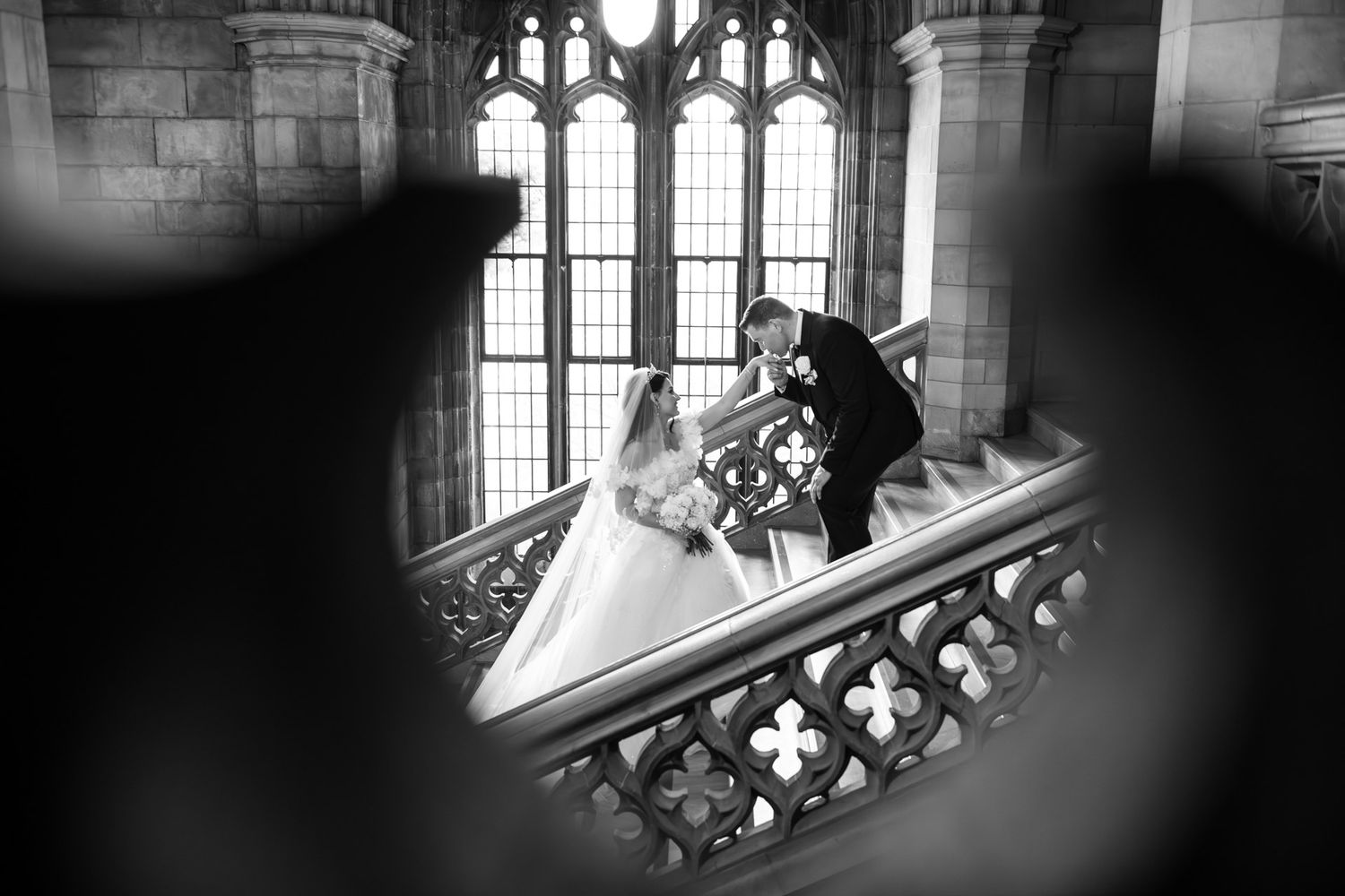 Bride and groom on the grand staircase at Knox College,  Toronto wedding photography capturing timeless moments.