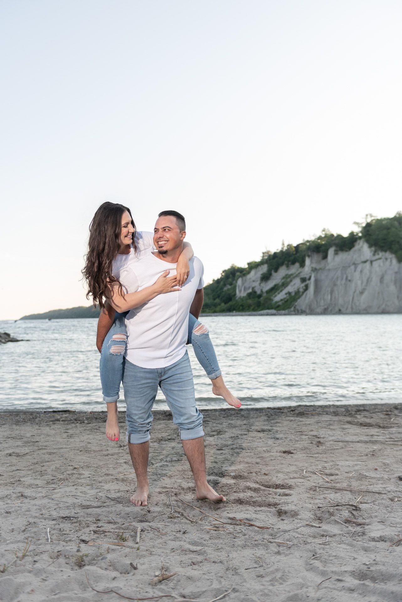 Couple enjoying a romantic engagement photoshoot by the water at Scarborough Bluffs in Toronto.