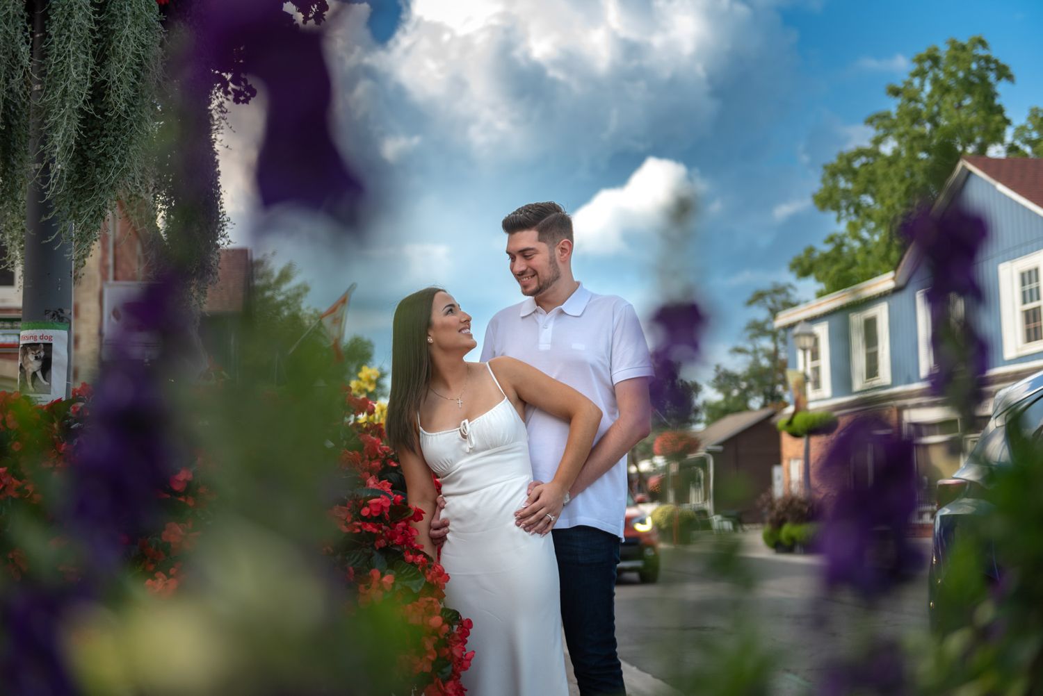 Natural engagement photoshoot in Unionville featuring a couple surrounded by colorful flowers.