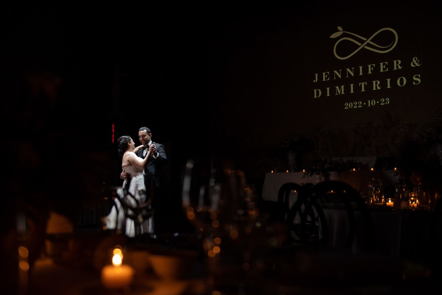 Newlyweds sharing their first dance by candlelight. Elegant Toronto wedding photography and real emotions.