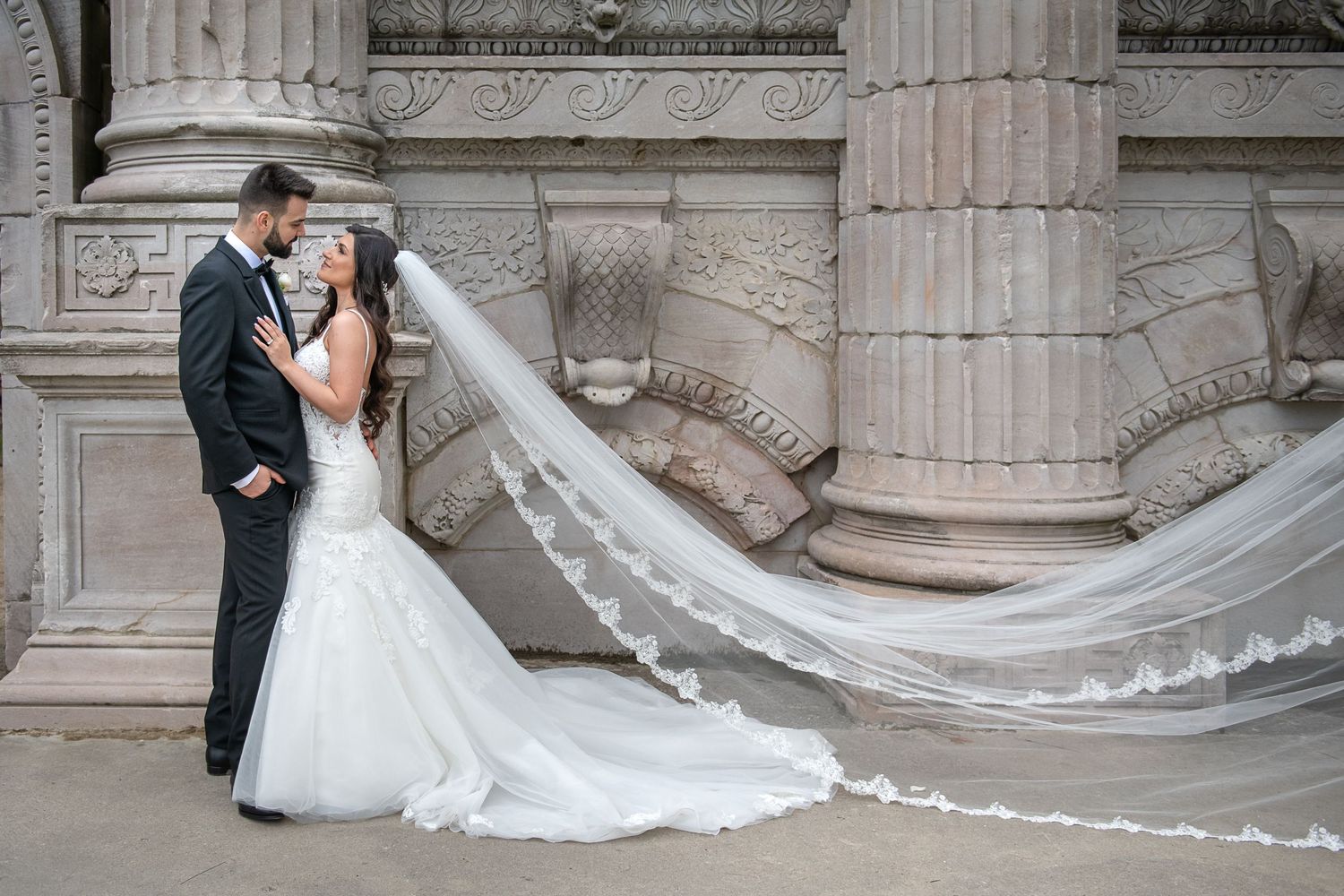Bride and groom portrait featuring a flowing wedding veil at Guildwood Park in Toronto.