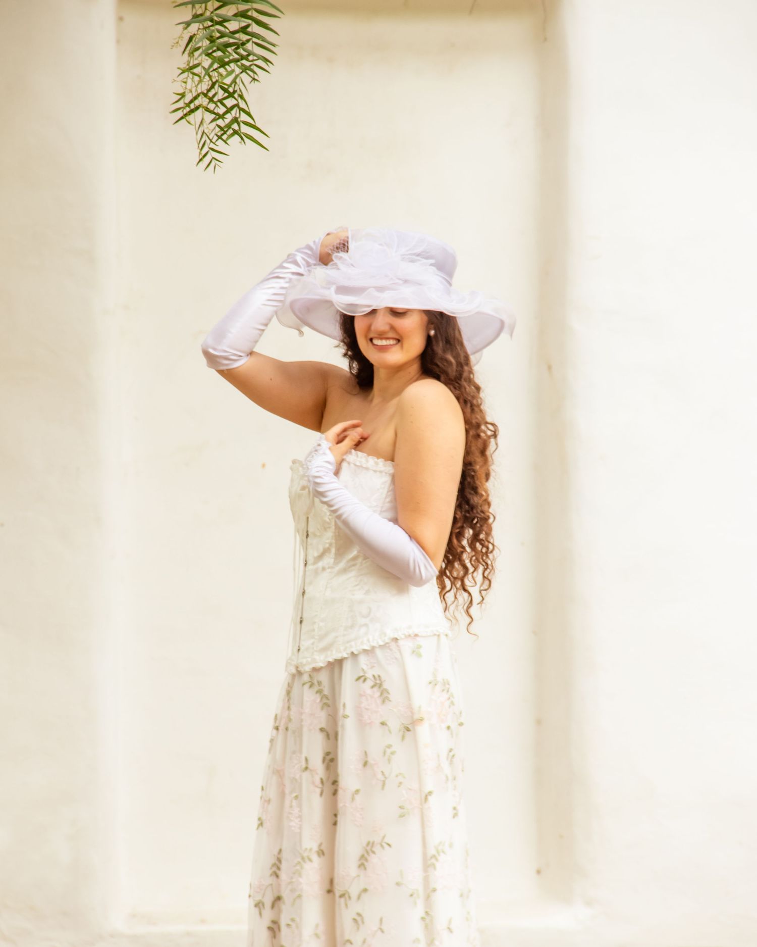 Woman in floral dress smiling under soft light | Nuvue Visuals natural light portrait photography in San Diego