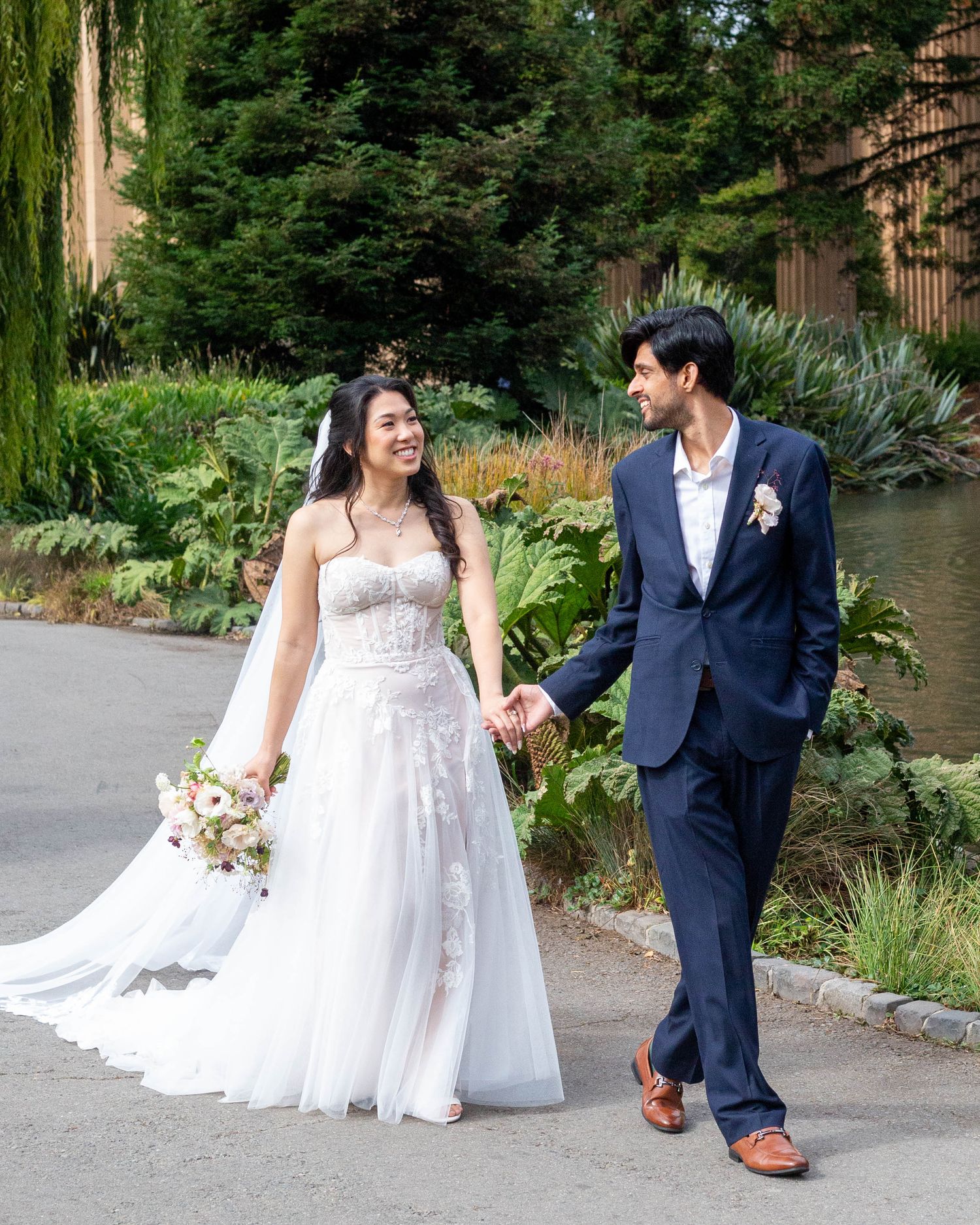 Bride and groom walking hand in hand outdoors | Nuvue Visuals candid wedding photography in San Francisco