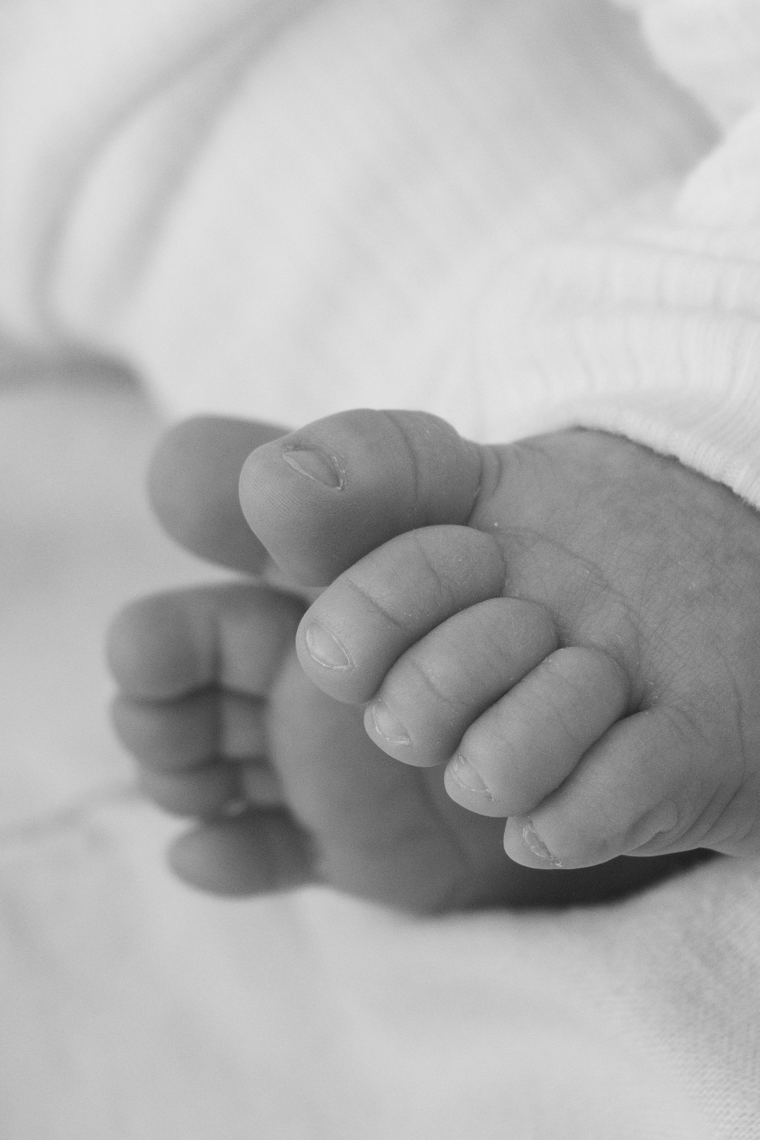 Candid, natural, close up newborn photos at sunset at a beach in Perth.