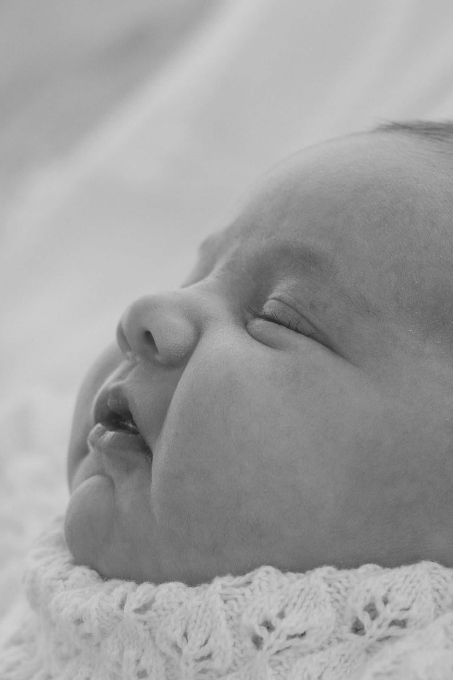 Candid, natural, close up newborn photos at sunset at a beach in Perth.