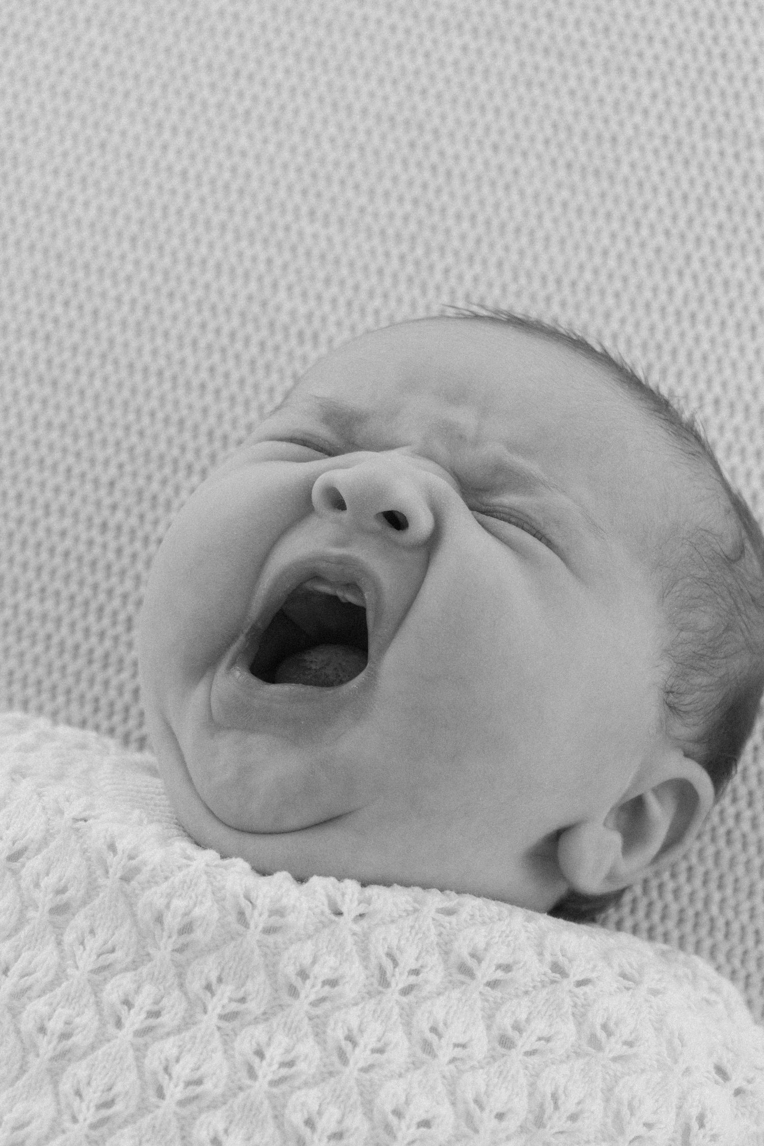 Candid, natural, close up newborn photos at sunset at a beach in Perth.