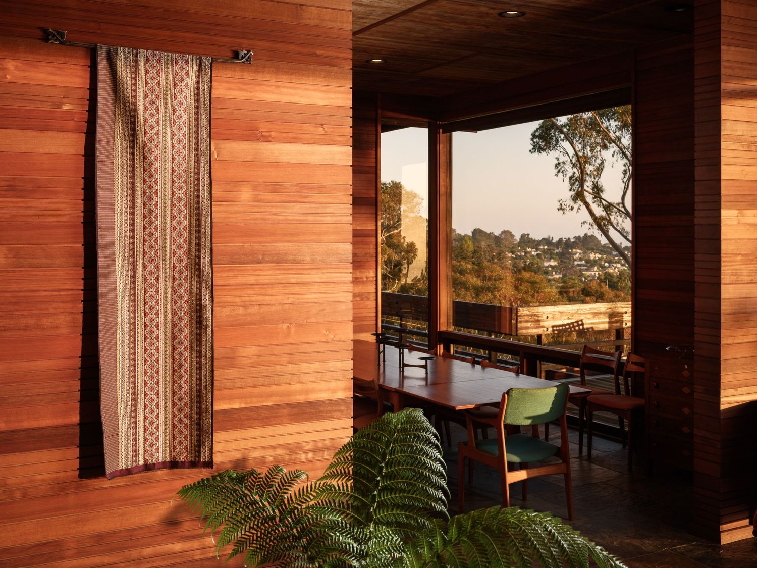 Cedar dining room at 7226 Romero in La Jolla, interior design photography san diego with hillside views at golden hour.