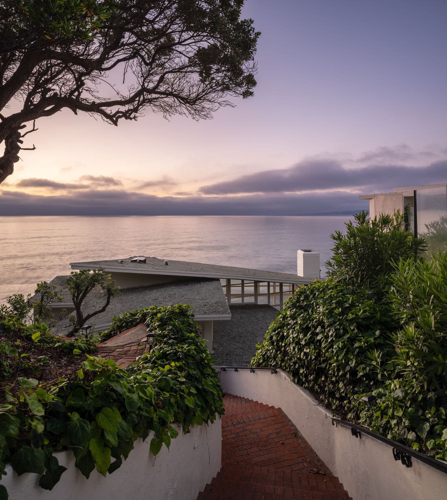 Coastal approach to 1890 Spindrift Drive overlooking the Pacific Ocean, highlighting its cliffside setting and historic midcentury architect