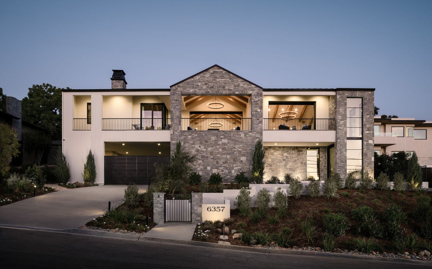 La Jolla 6357 Castejon modern luxury home exterior with stone and stucco facade at twilight