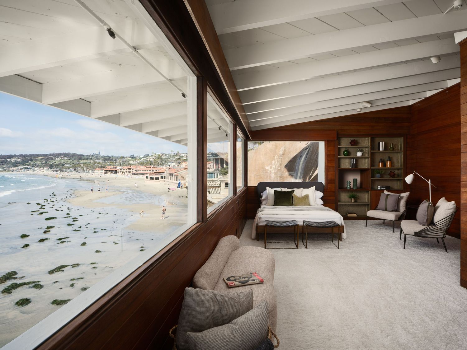 Bedroom overlooking the La Jolla shoreline at 1890 Spindrift Drive with wraparound glass, midcentury details, and beach views.