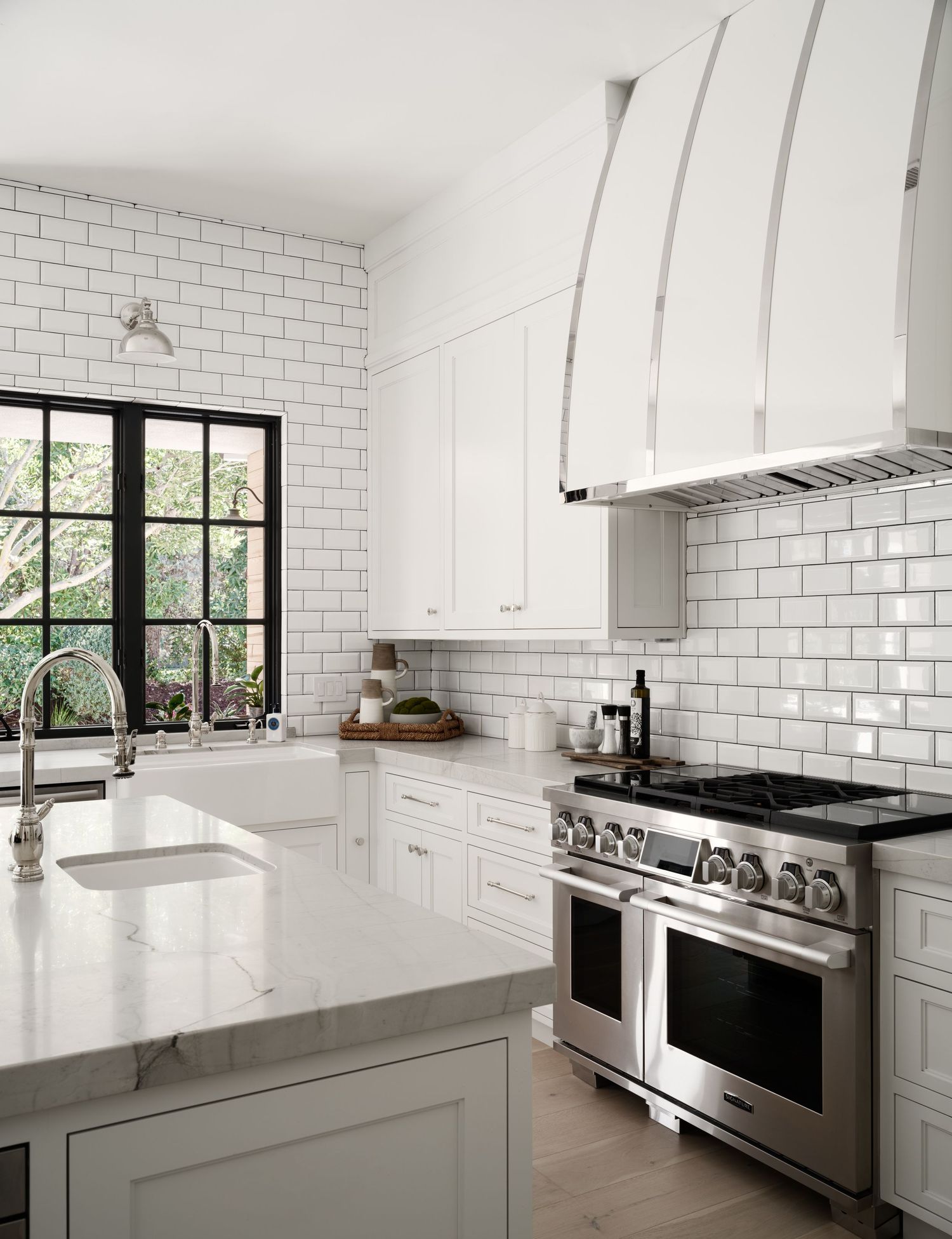 Bright Rancho Santa Fe luxury kitchen with marble countertops, subway tile backsplash, and professional range—interior photography