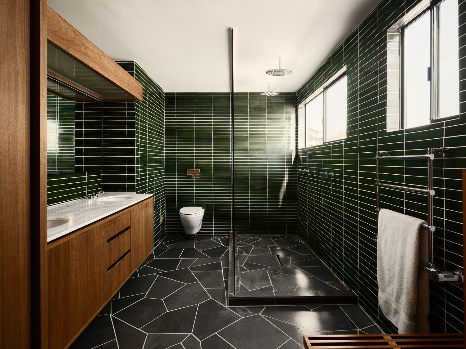 Bathroom with glossy green Heath tile, walk-in shower, wood vanity and slate floor at the Liepman Residence, 2916 Chicago St design photo