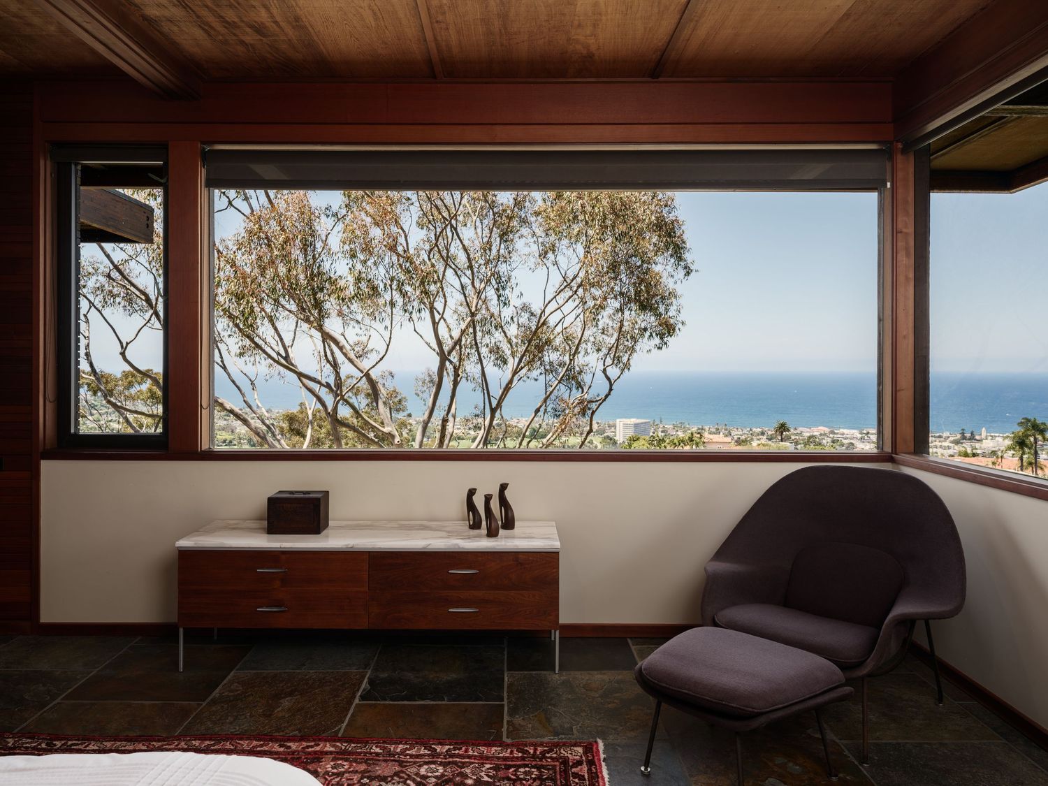 Bedroom seating area at 7226 Romero with panoramic ocean views, real estate photography san diego capturing midcentury style.