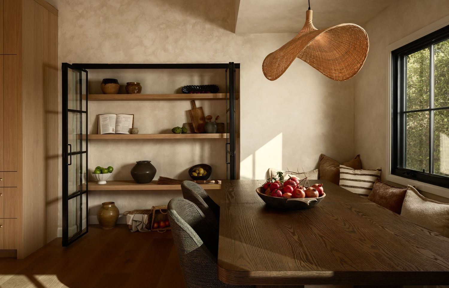 La Jolla dining nook with limewash walls, custom shelving, and natural light, photographed for architectural and luxury real estate
