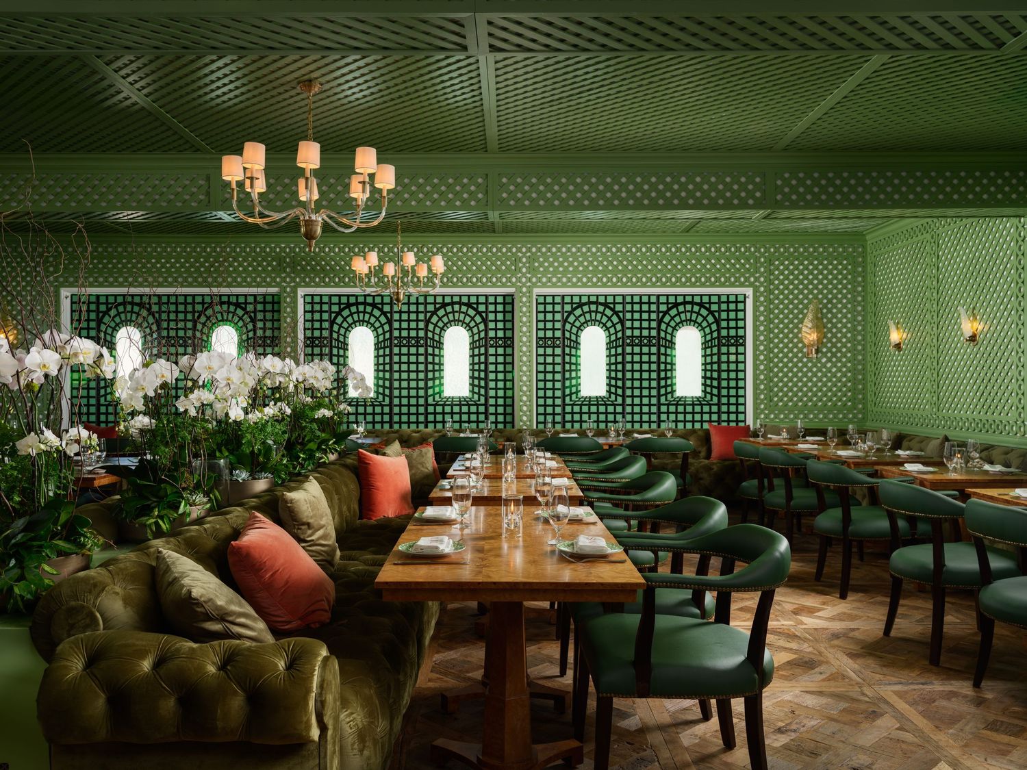 Lilian’s restaurant interior at The Inn at Rancho Santa Fe — lush green lattice walls, velvet seating, chandeliers — luxury interior design