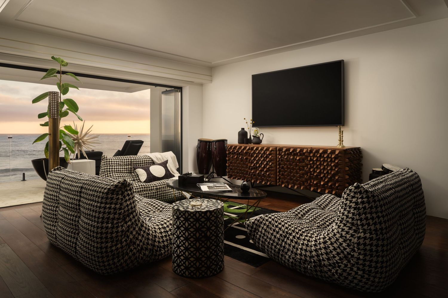 Carlsbad Ocean Street beachfront mansion living room with ocean views, sculptural furniture, and modern coastal design